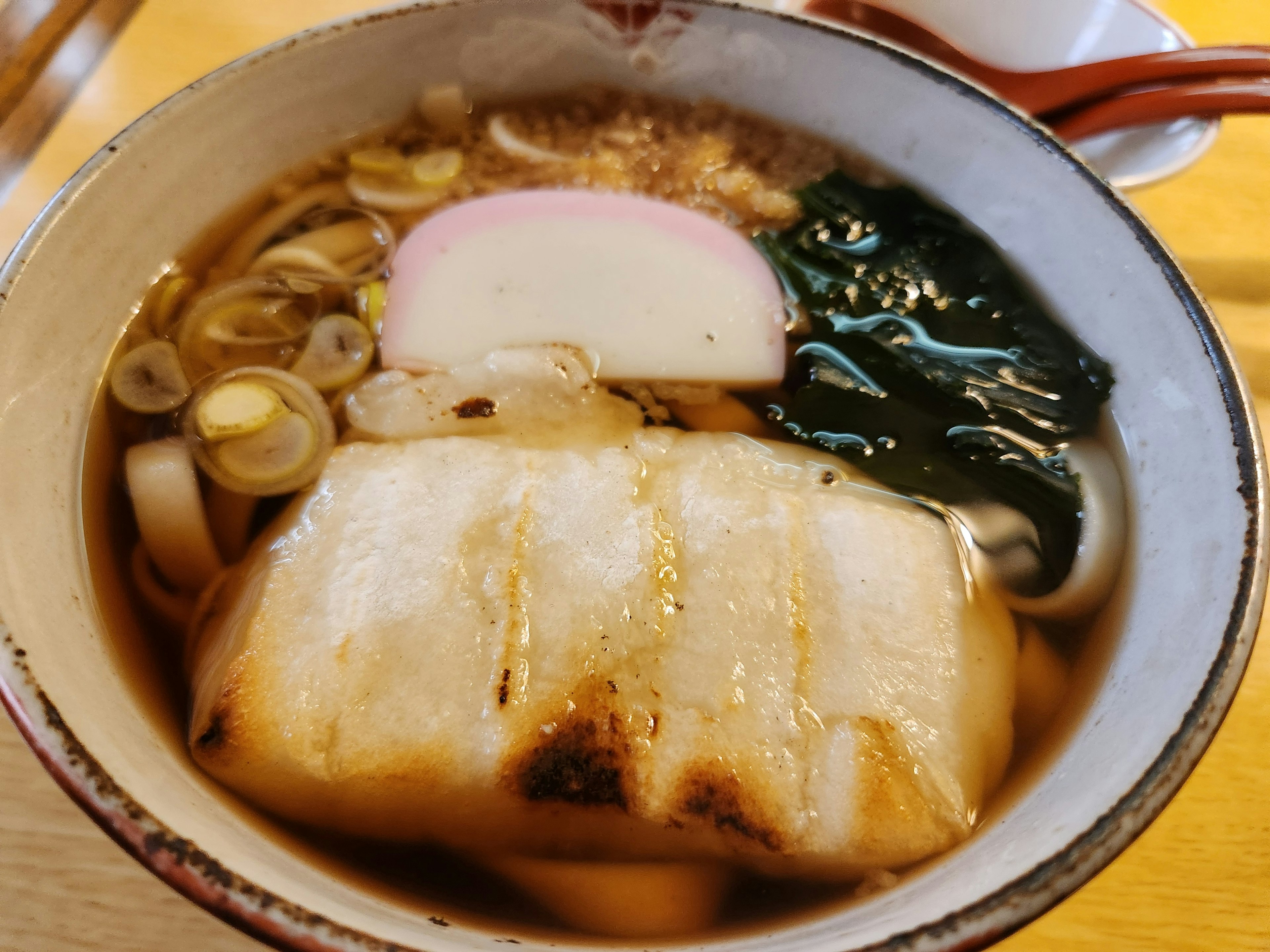 Bowl of ramen topped with grilled fish