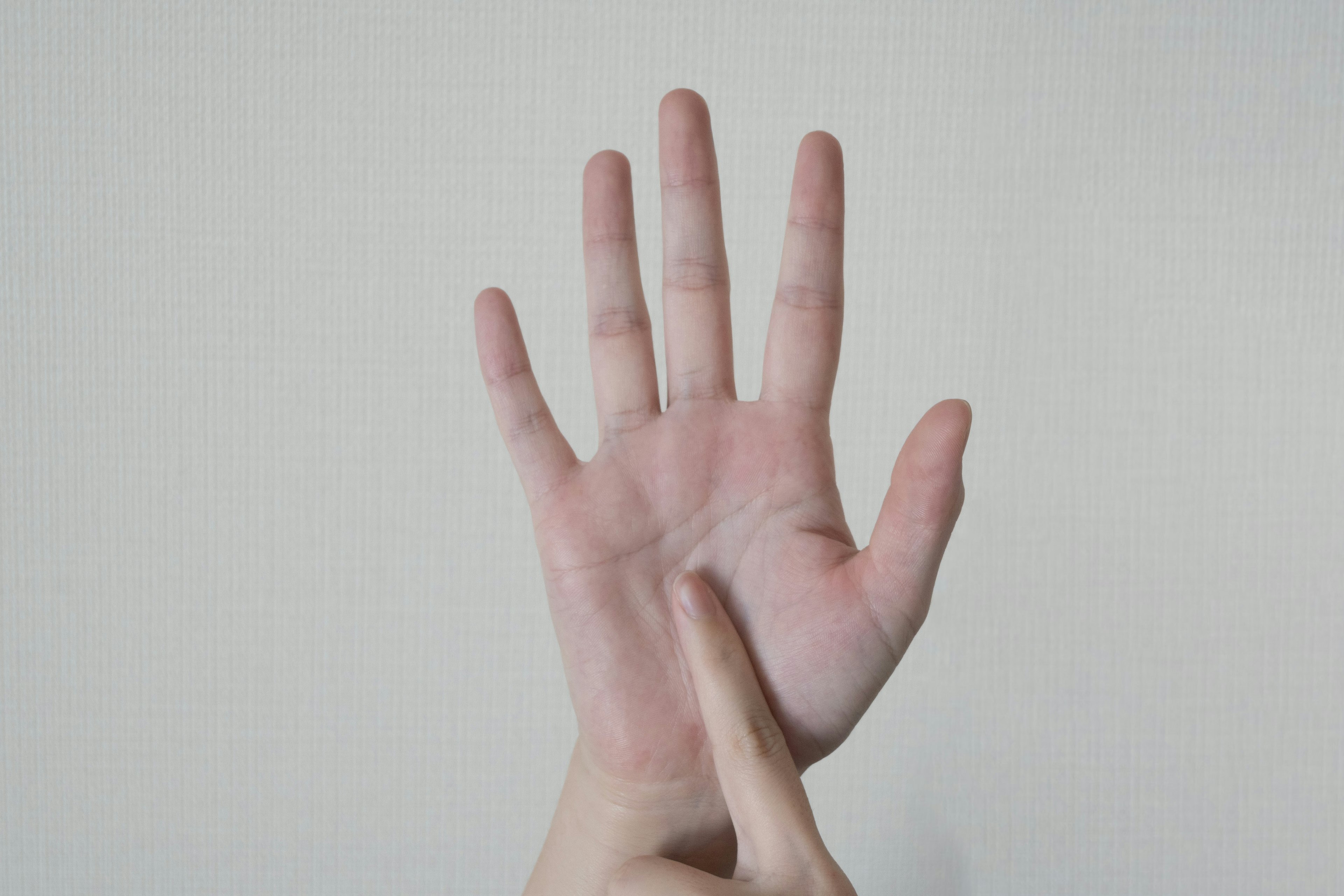 A hand with palm facing up and a finger pointing at the palm