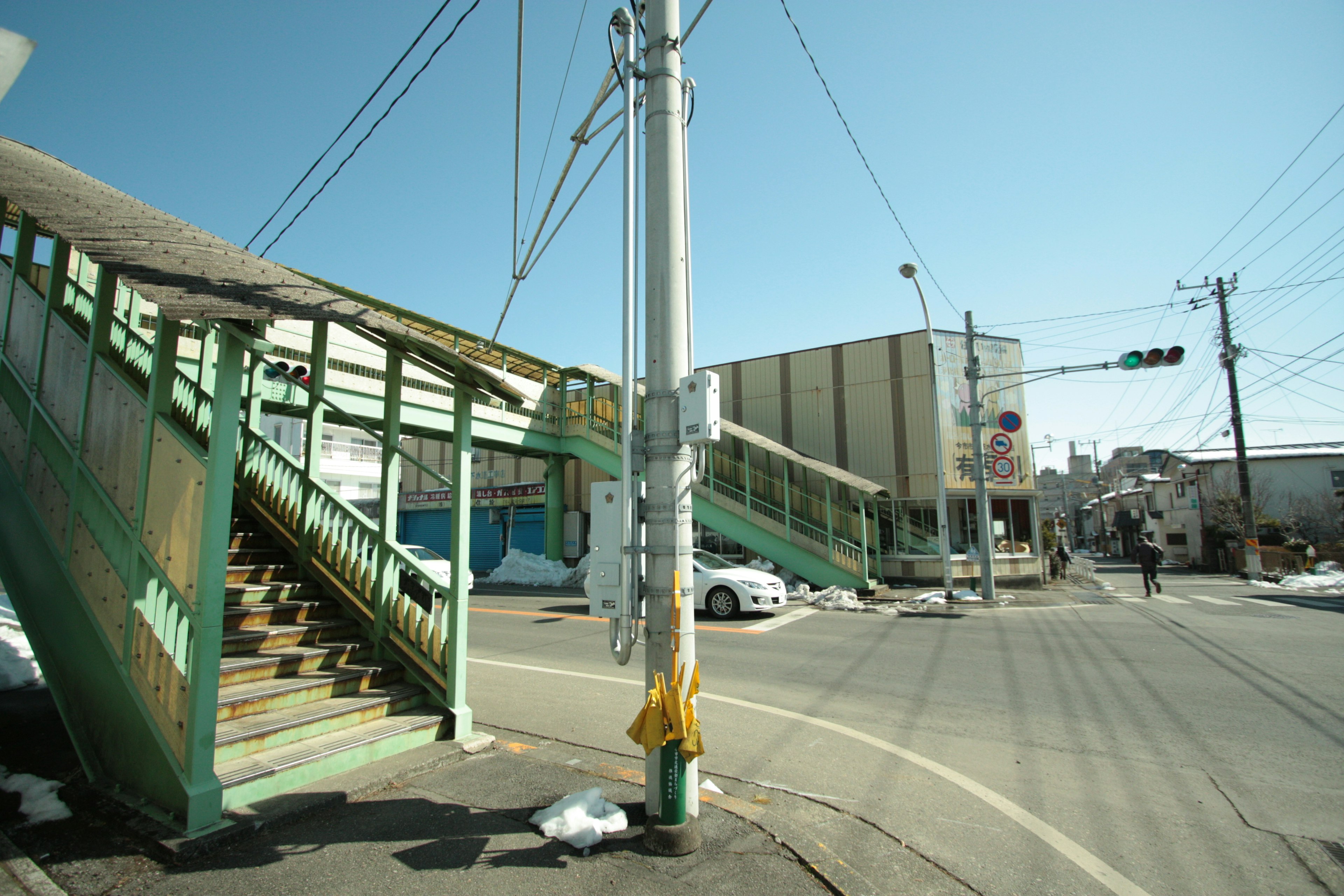 Staircase and intersection scene under a clear blue sky