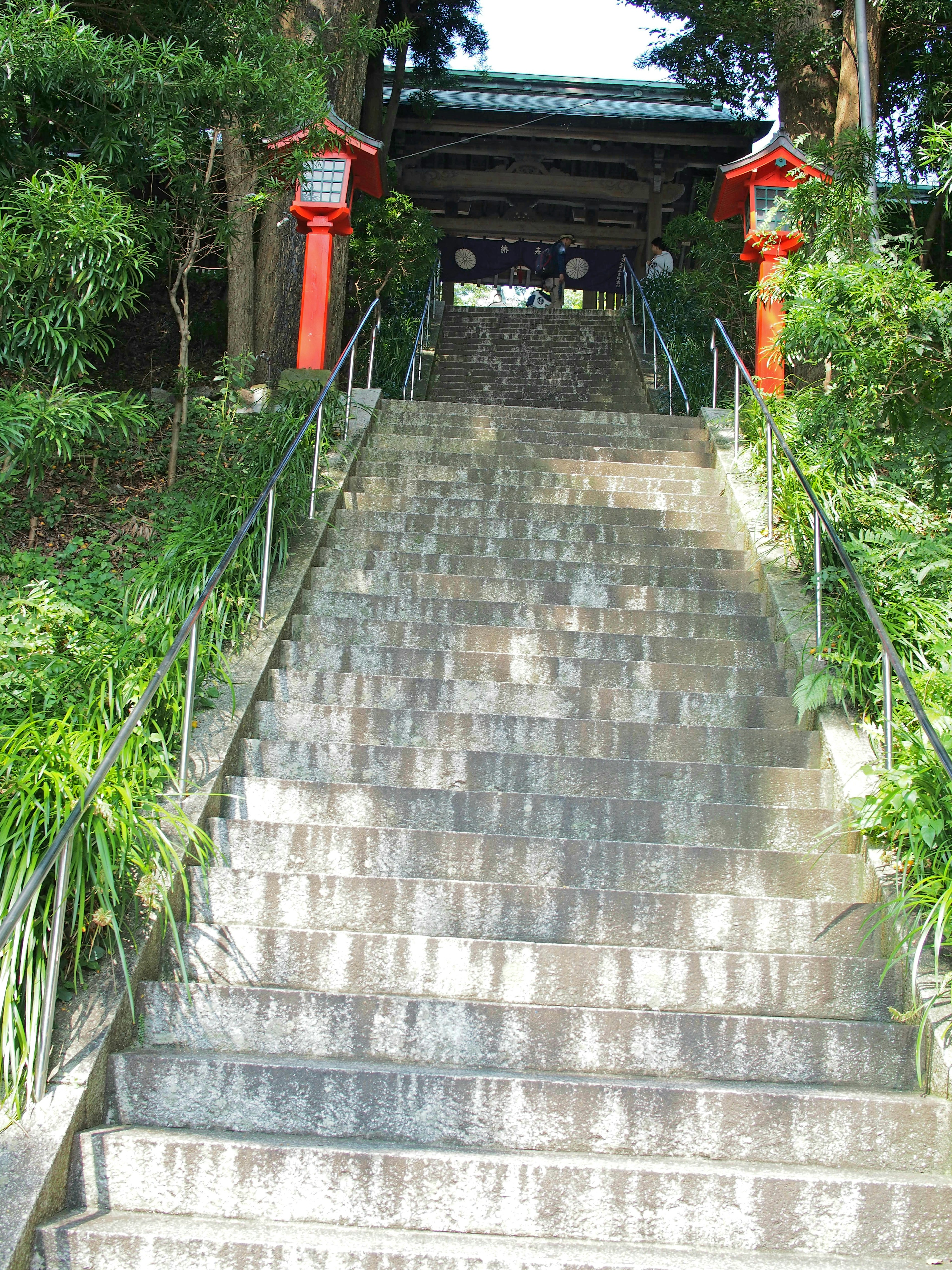 Stone steps leading to a shrine entrance with red torii gates