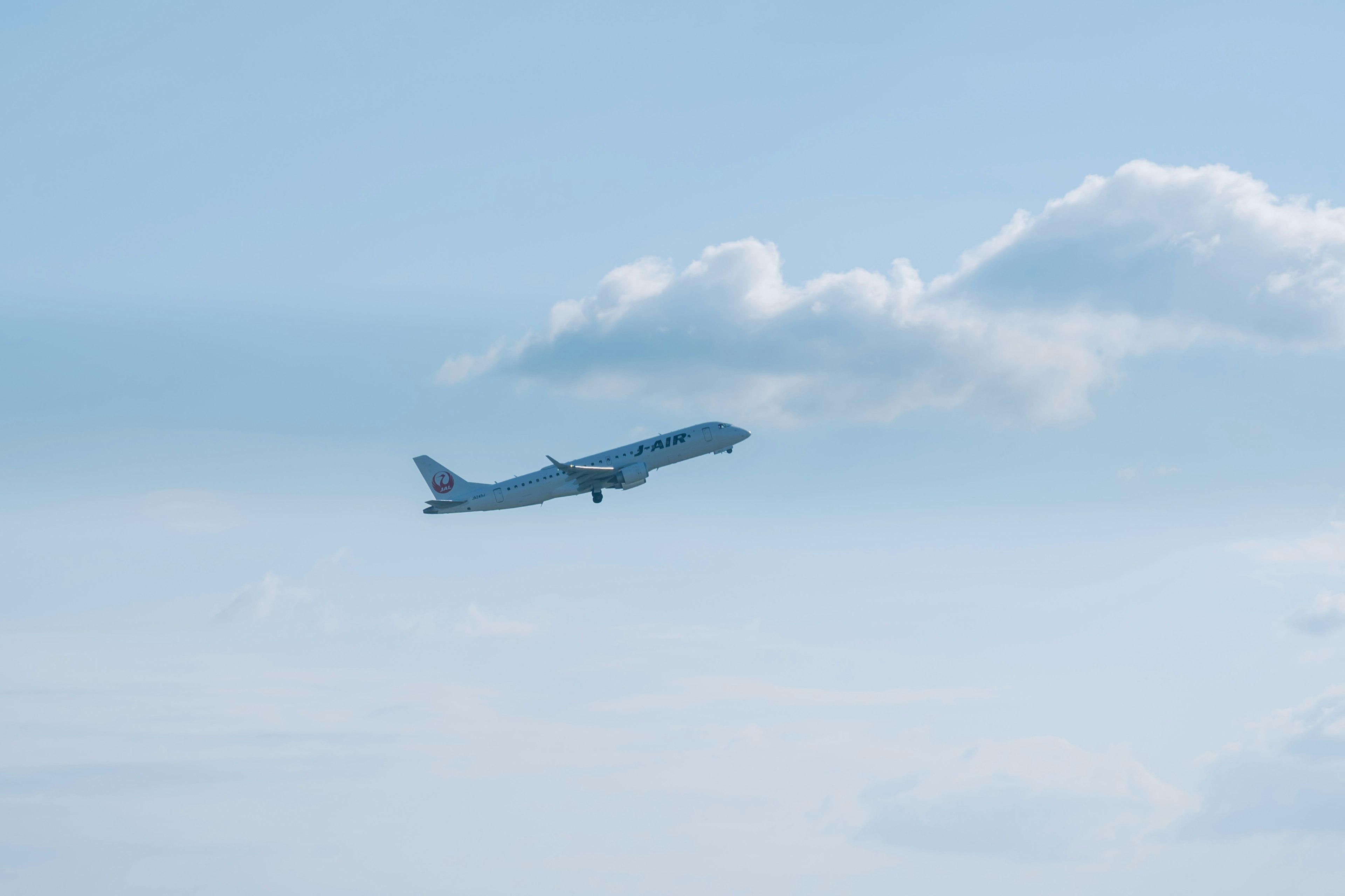 Airplane taking off against a blue sky