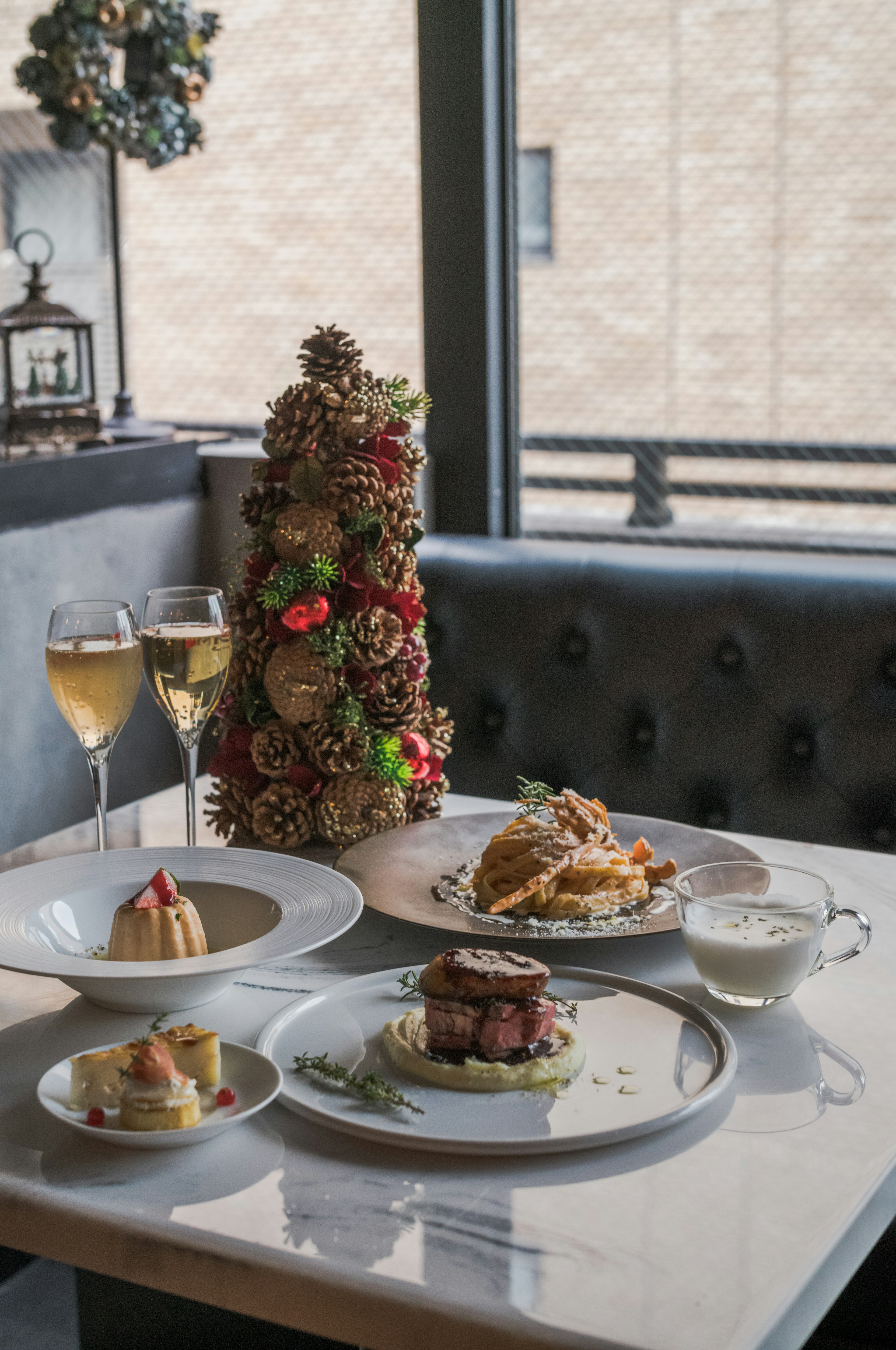 Beautifully arranged dishes on a table with a decorative Christmas tree