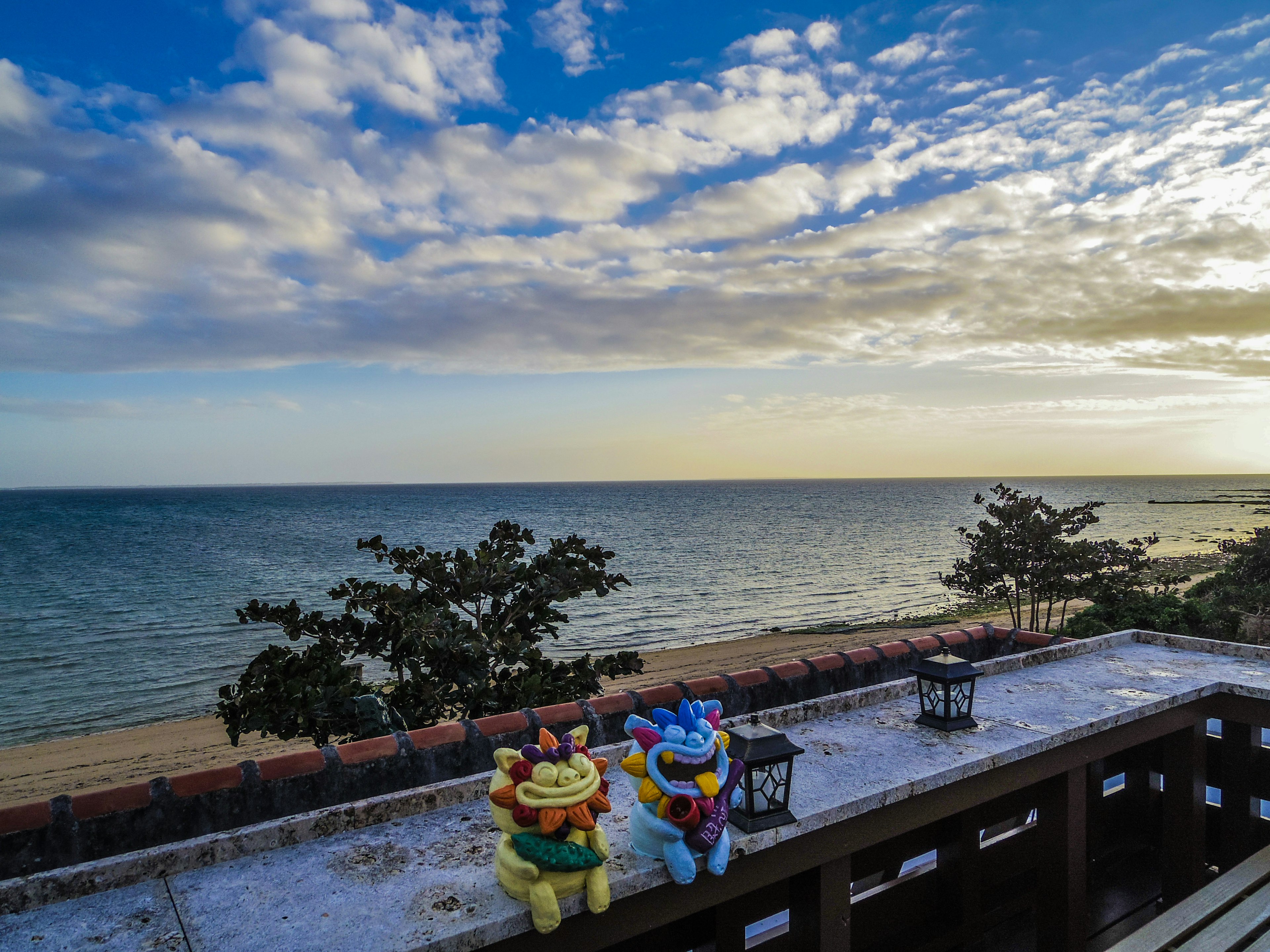 Colorful character figurines placed against a scenic ocean backdrop