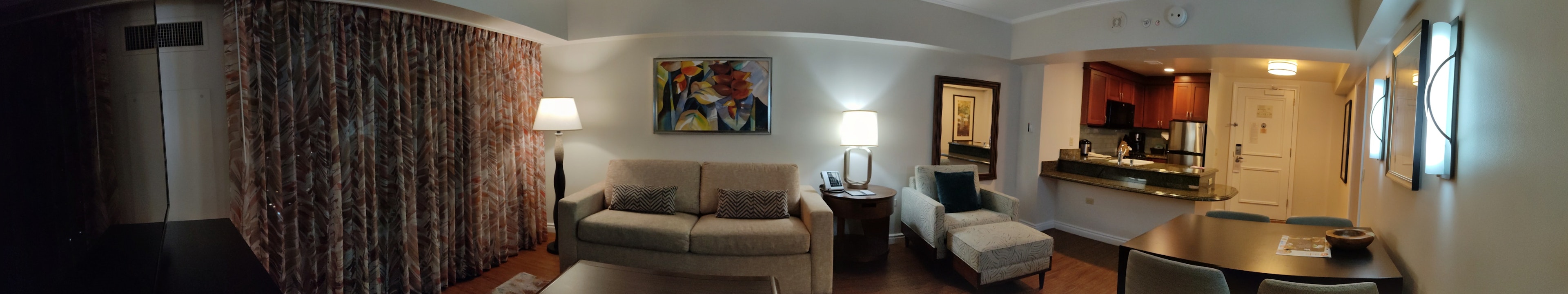 Cozy living room panorama featuring a sofa and table