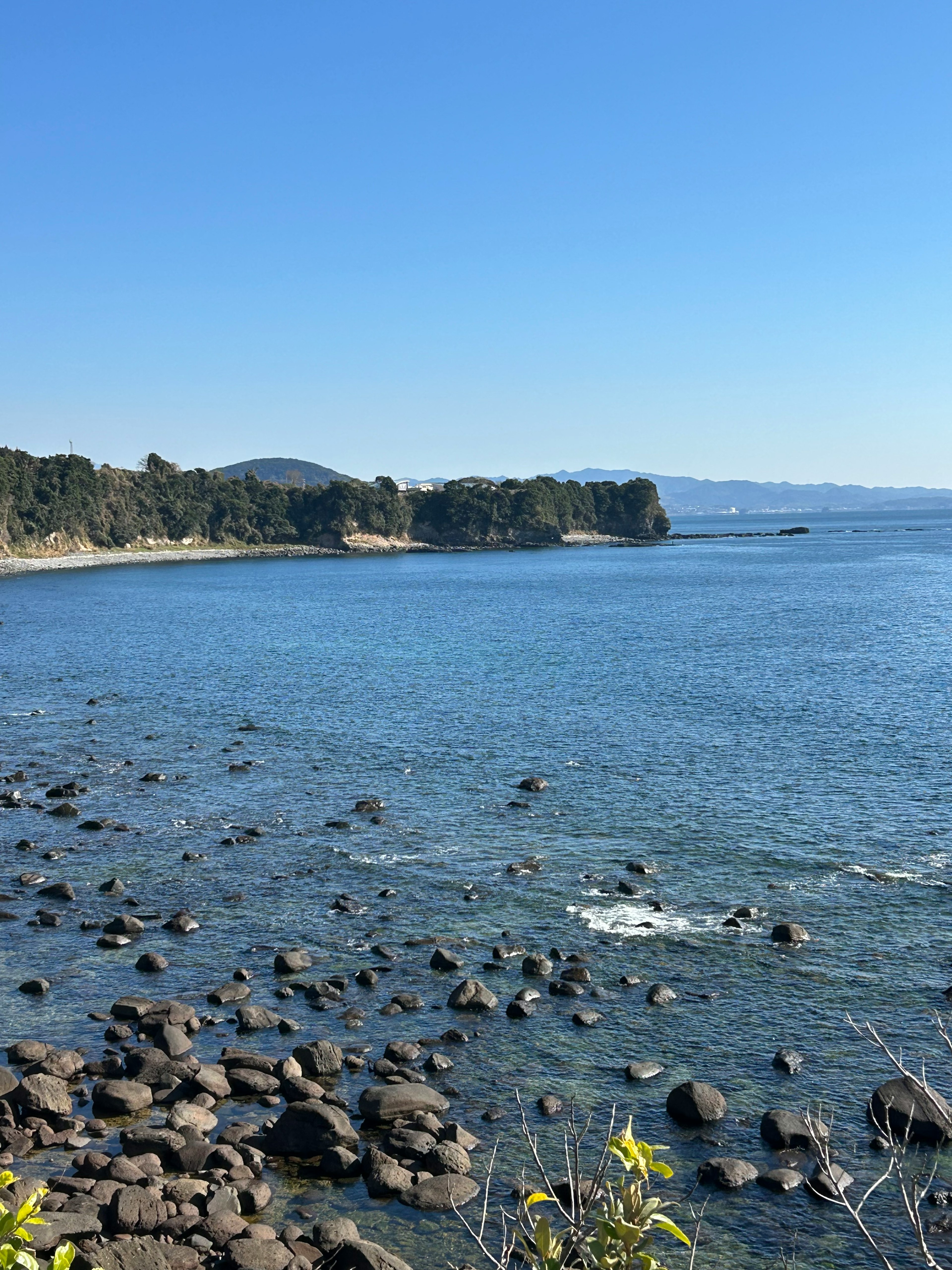 Coastal landscape with blue sea and rocky shoreline