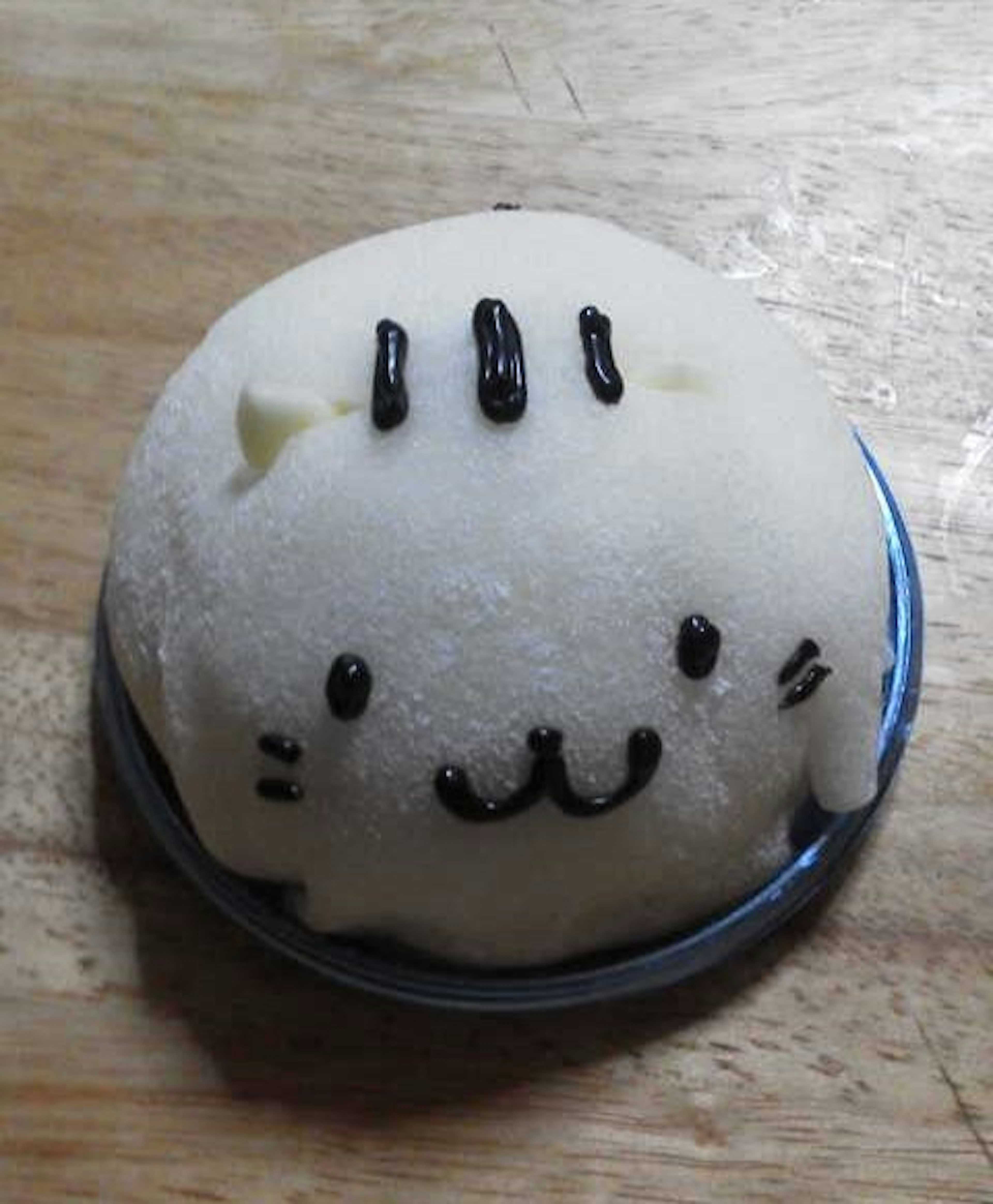 White cat-shaped dessert with black facial features