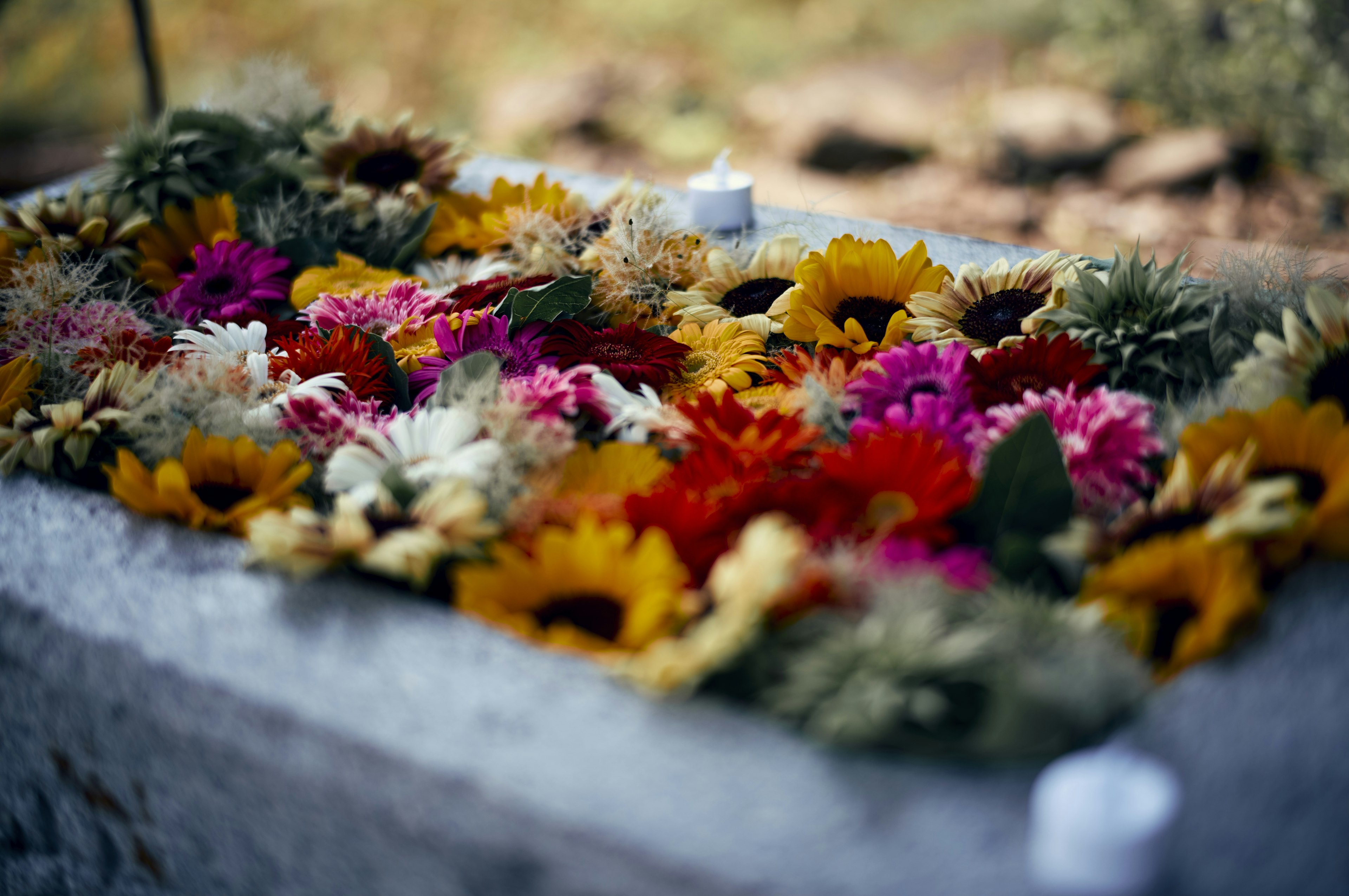 Colorful flowers arranged on a gravestone