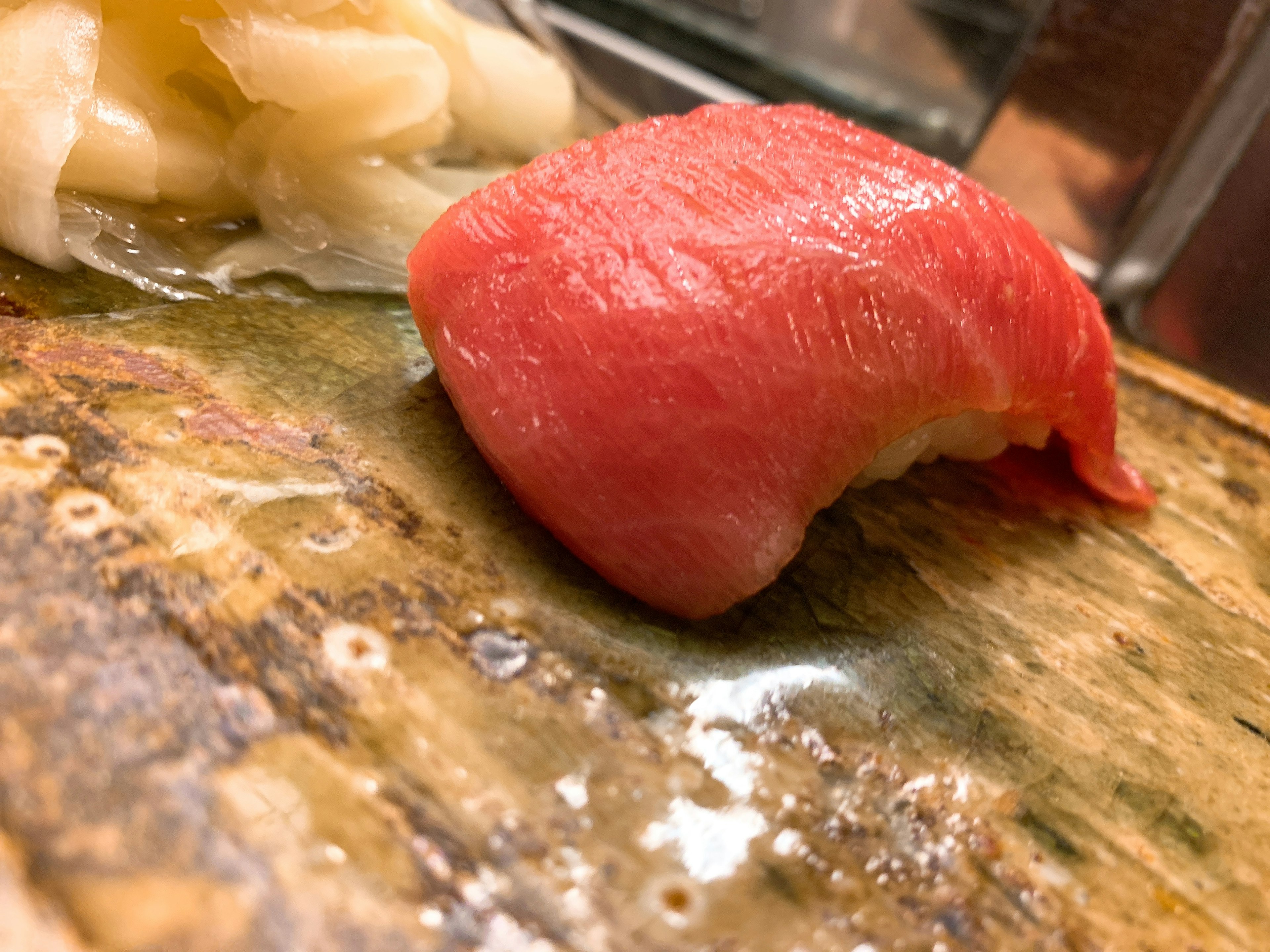 Fresh tuna sushi and pickled ginger on a wooden board