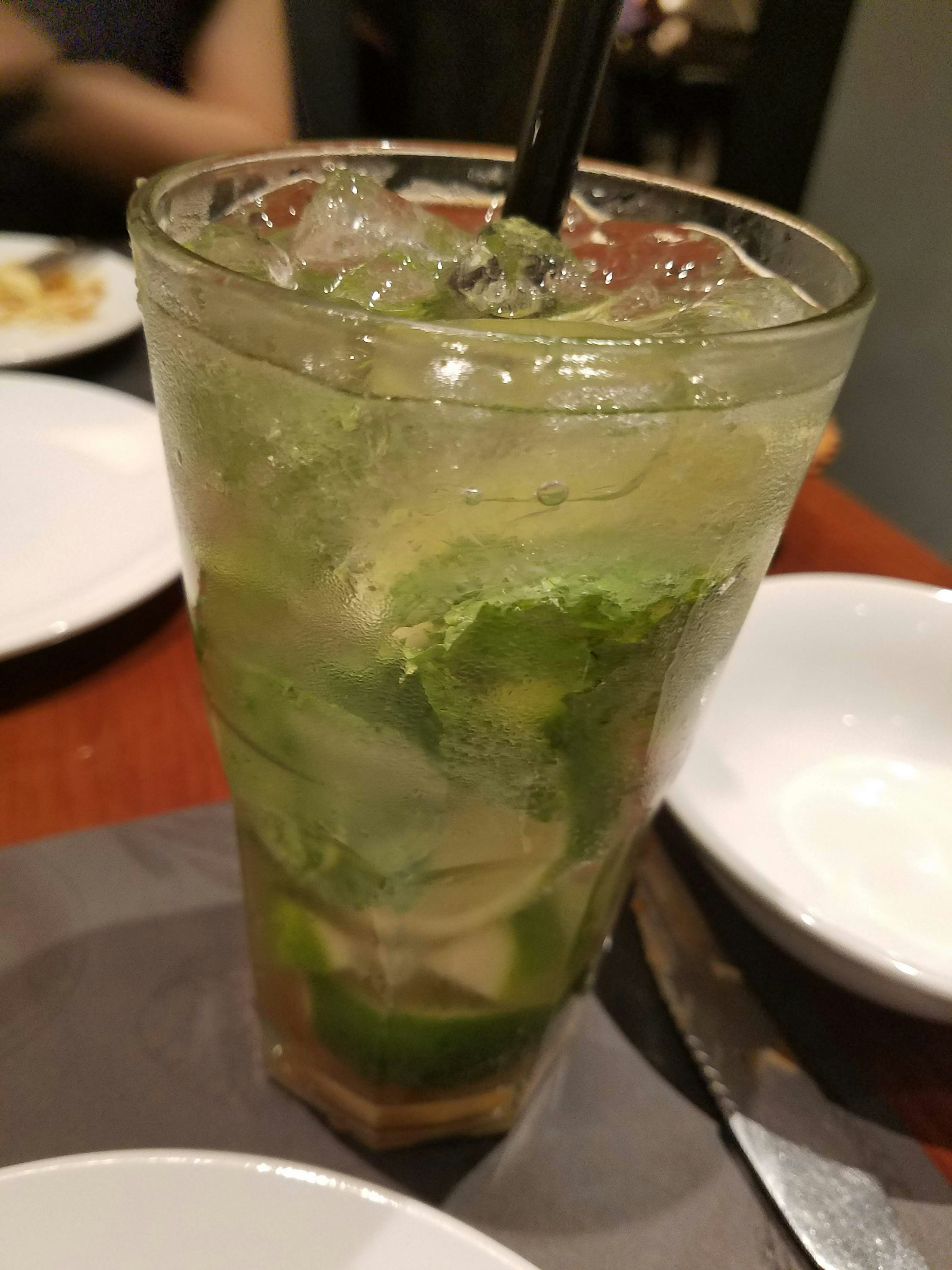 A glass of mojito with mint and lime