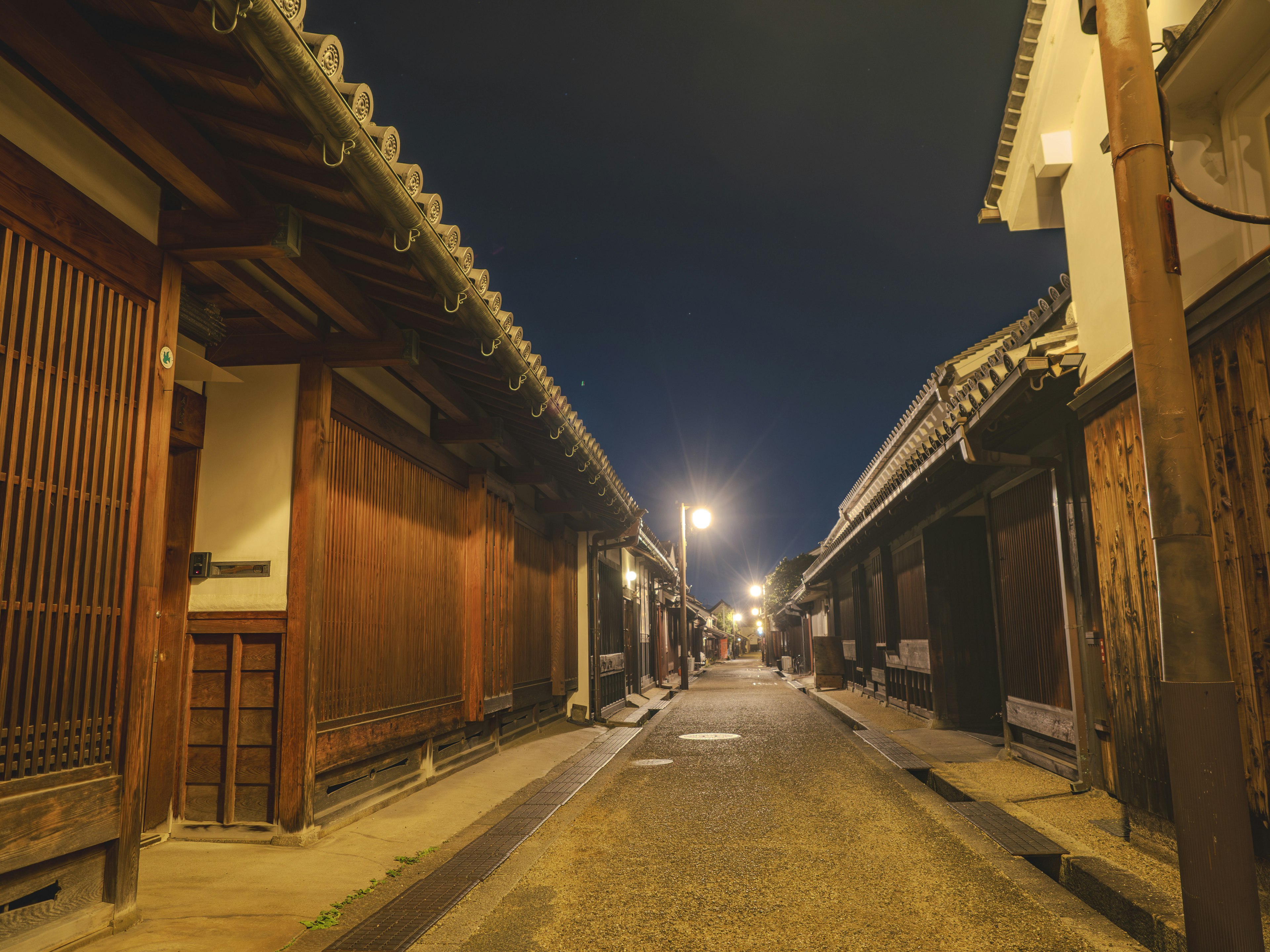 Quiet street of an old town at night with traditional wooden buildings