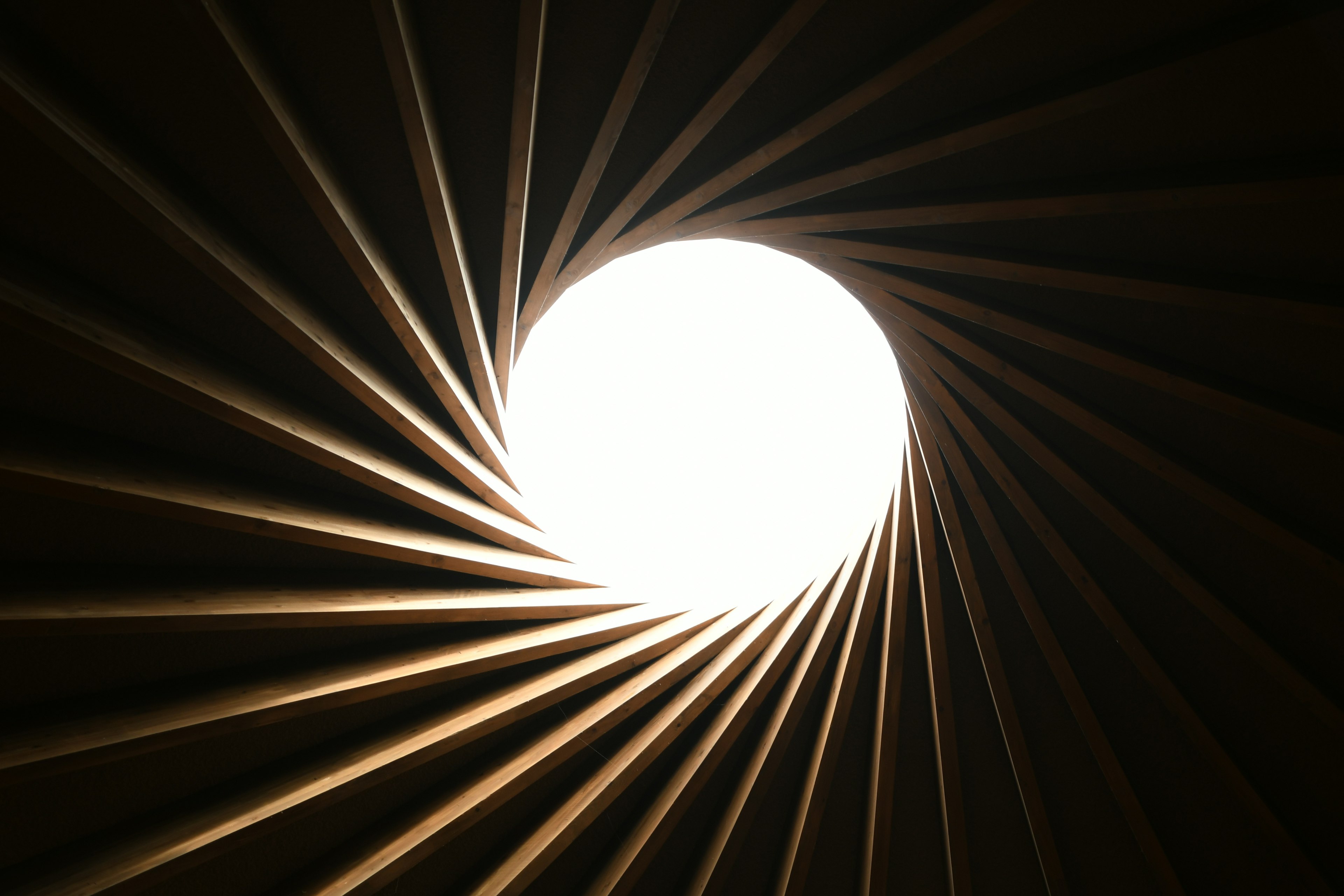 A spiral tunnel with a circular light at the end