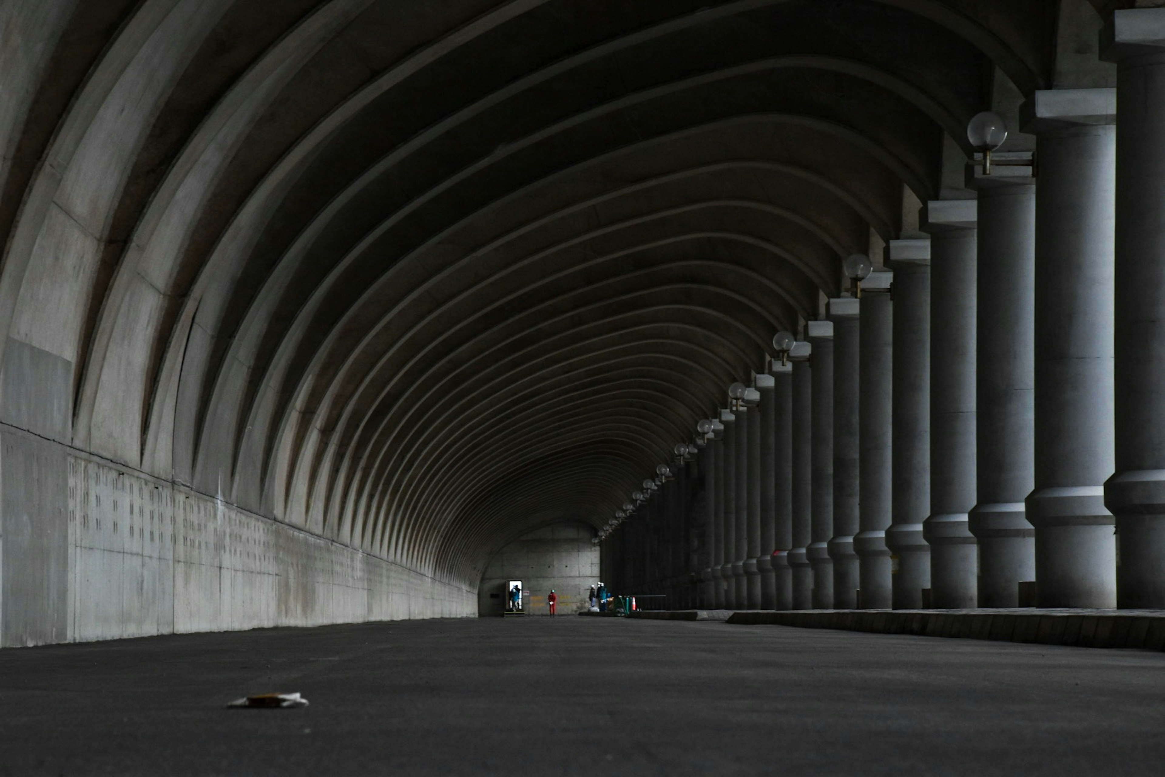 Interior de un túnel oscuro con techo arqueado y columnas