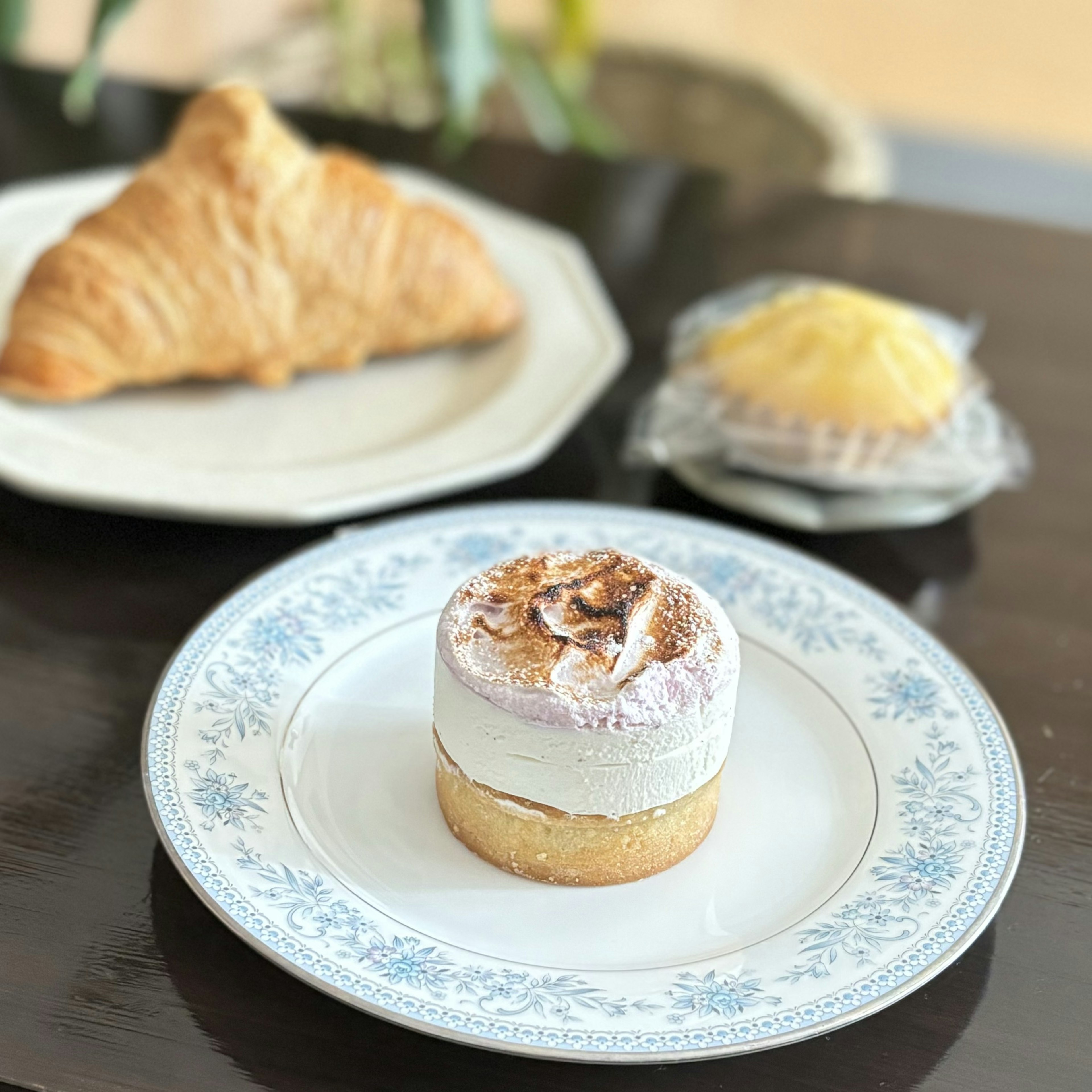 A plate with a cake and pastries on a table