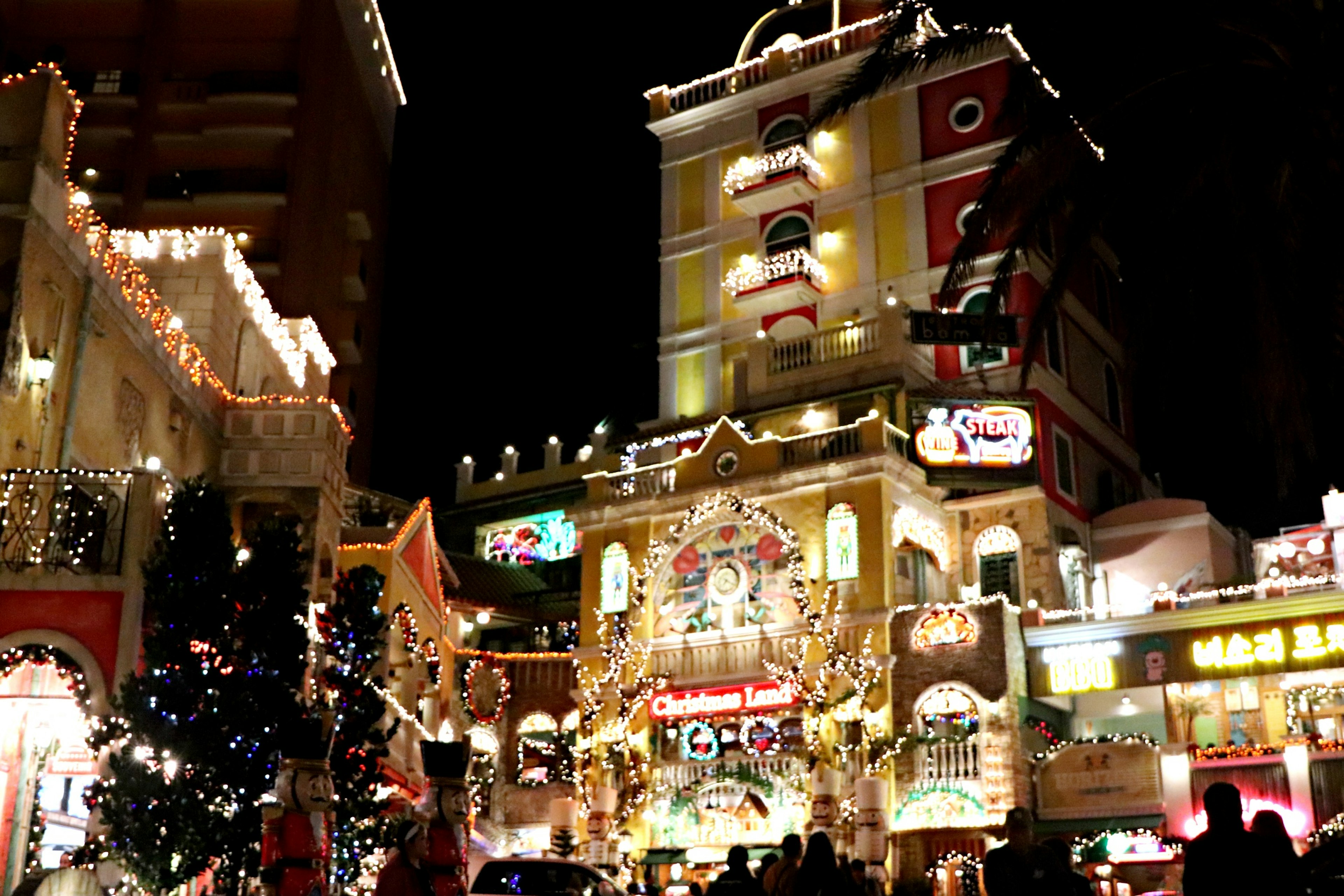 Vibrant buildings adorned with lights and decorations at night