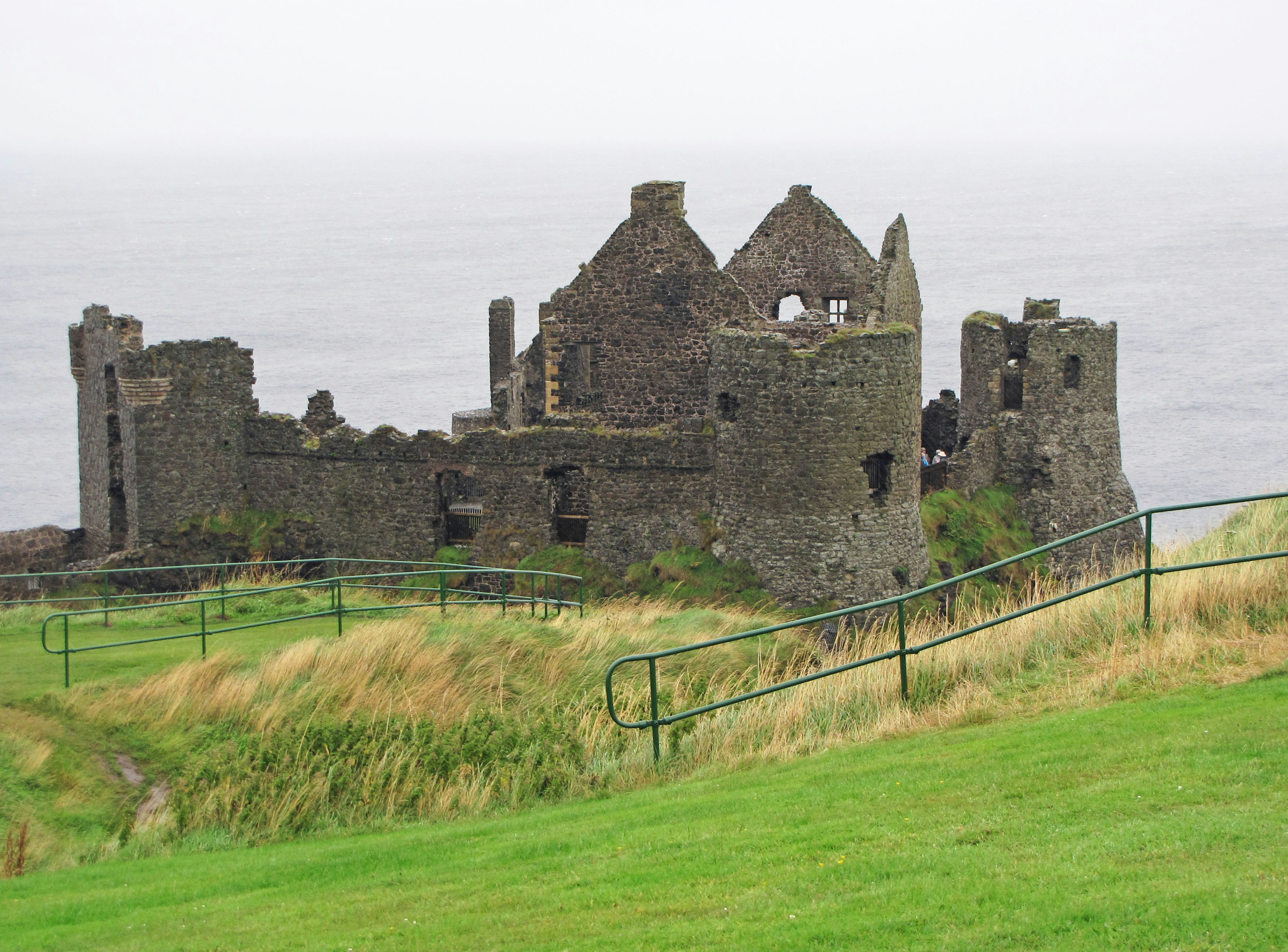 Ruined castle ruins standing against the ocean background