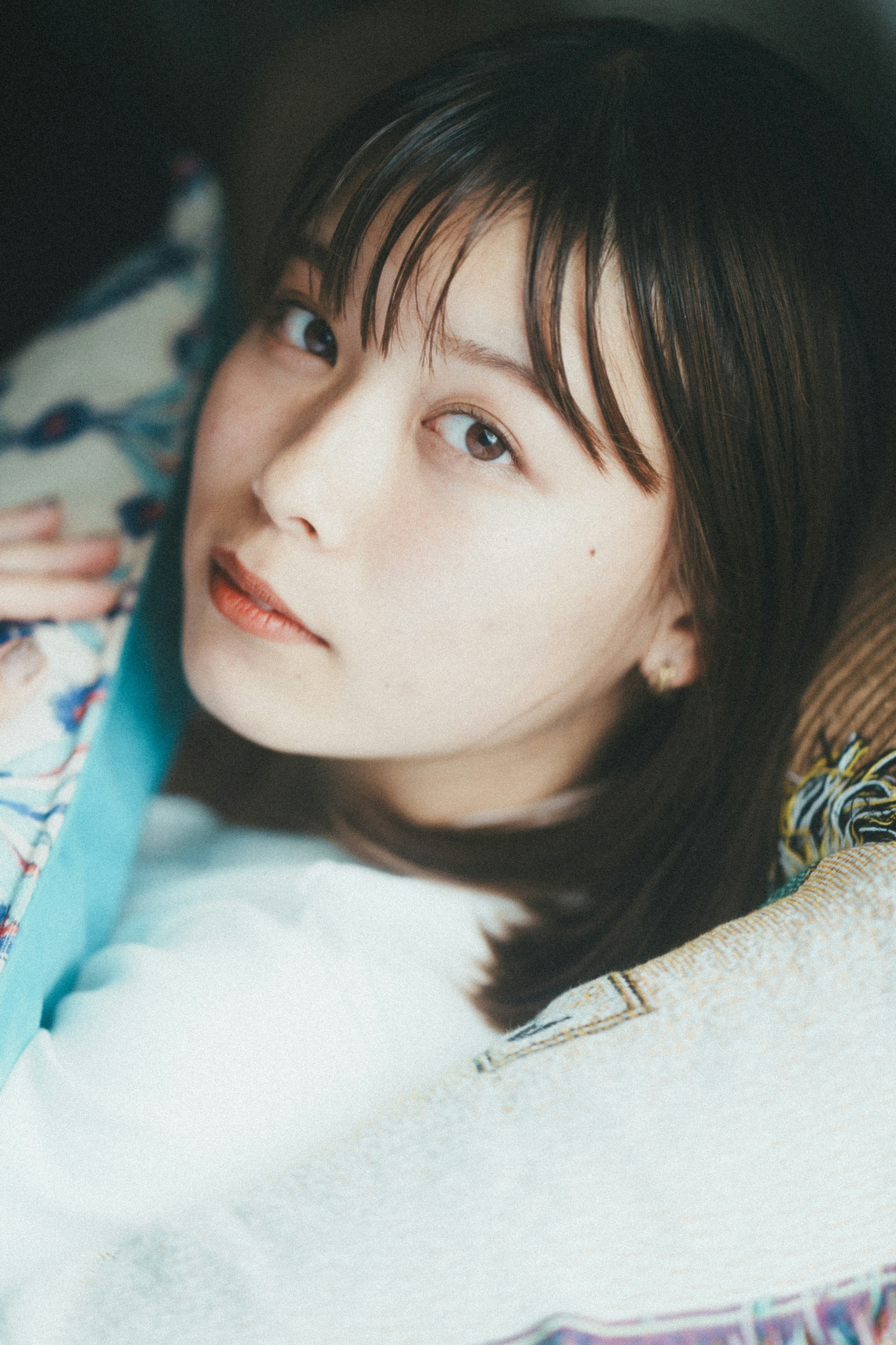 Portrait of a young woman leaning on a sofa