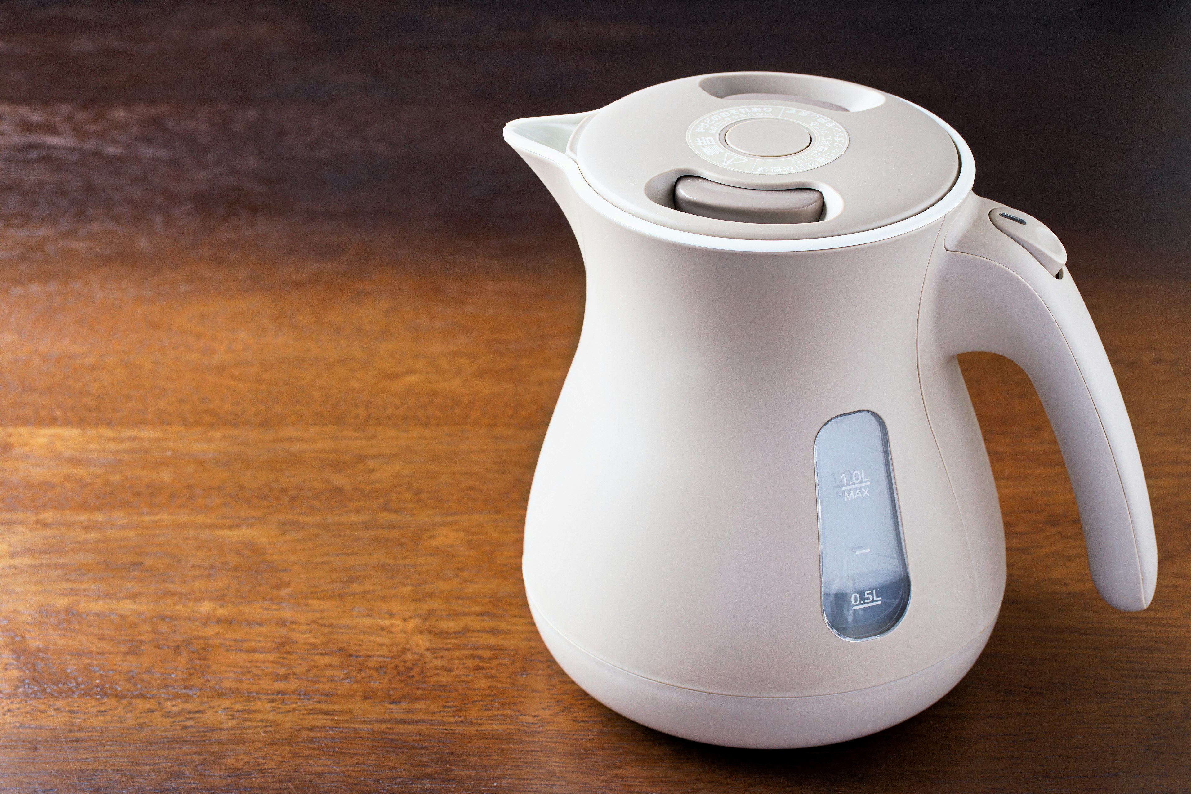 White electric kettle on a wooden table