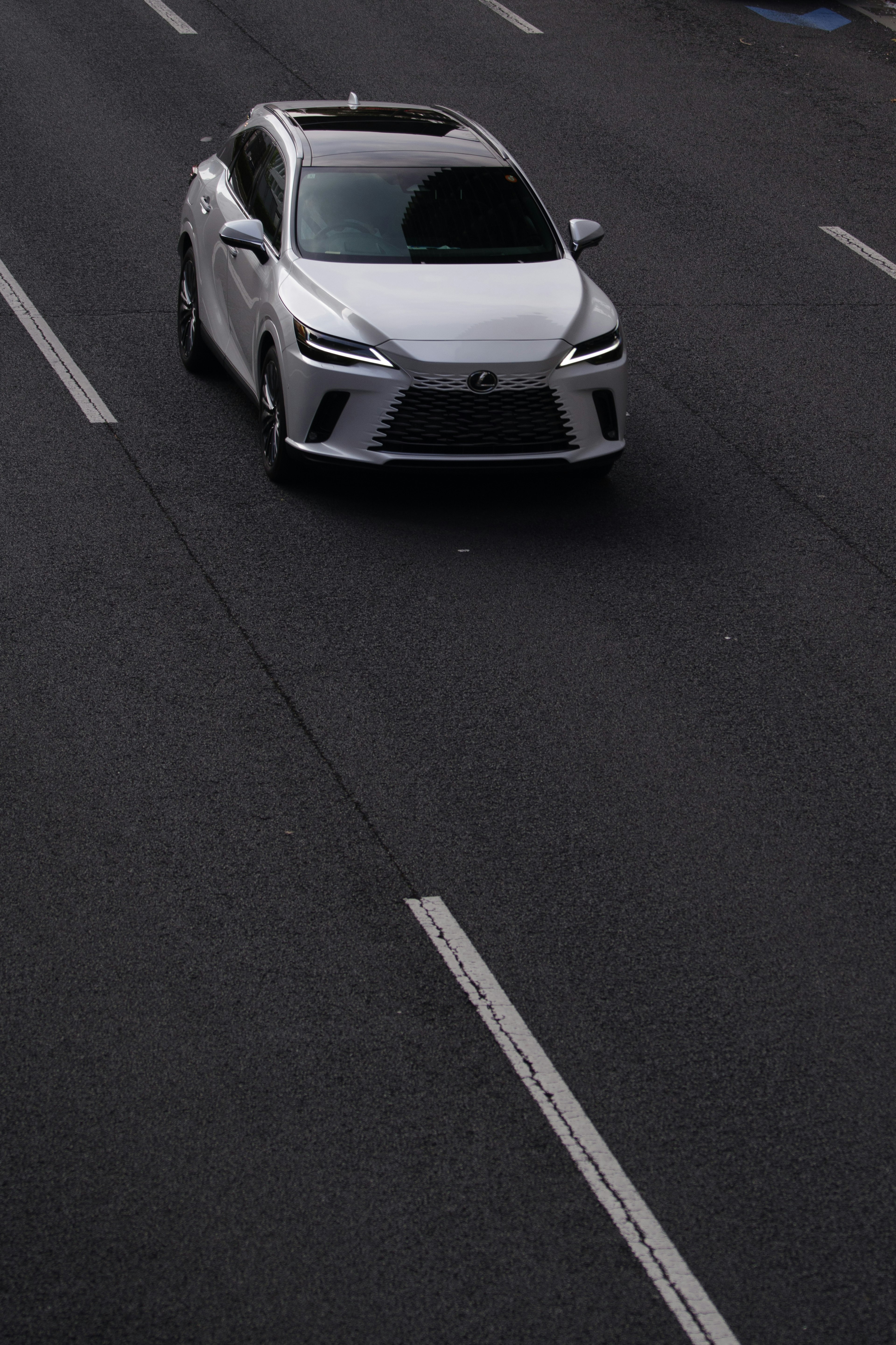 A white car driving on the road