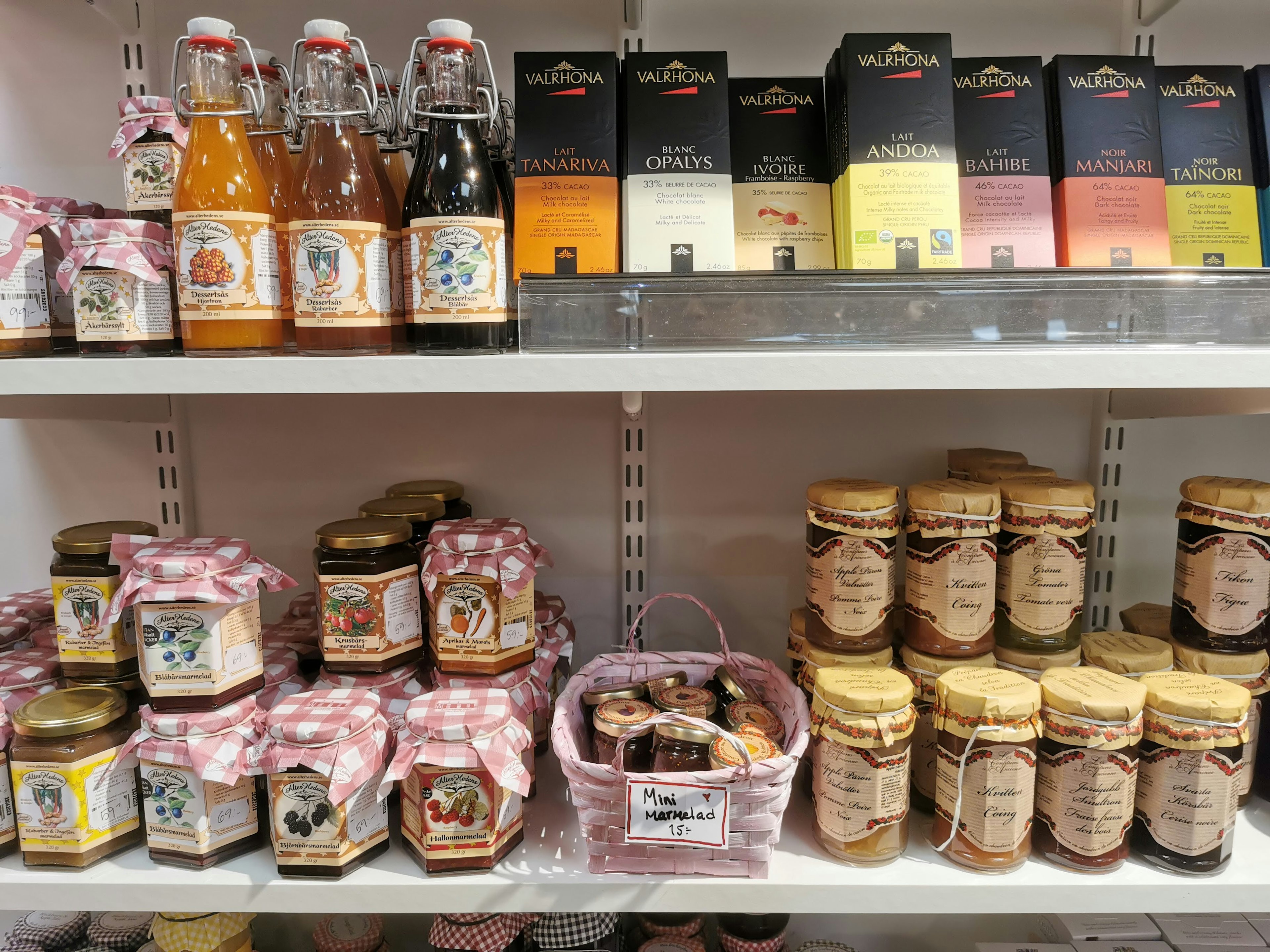 Shelves displaying various jars of jam and beverages