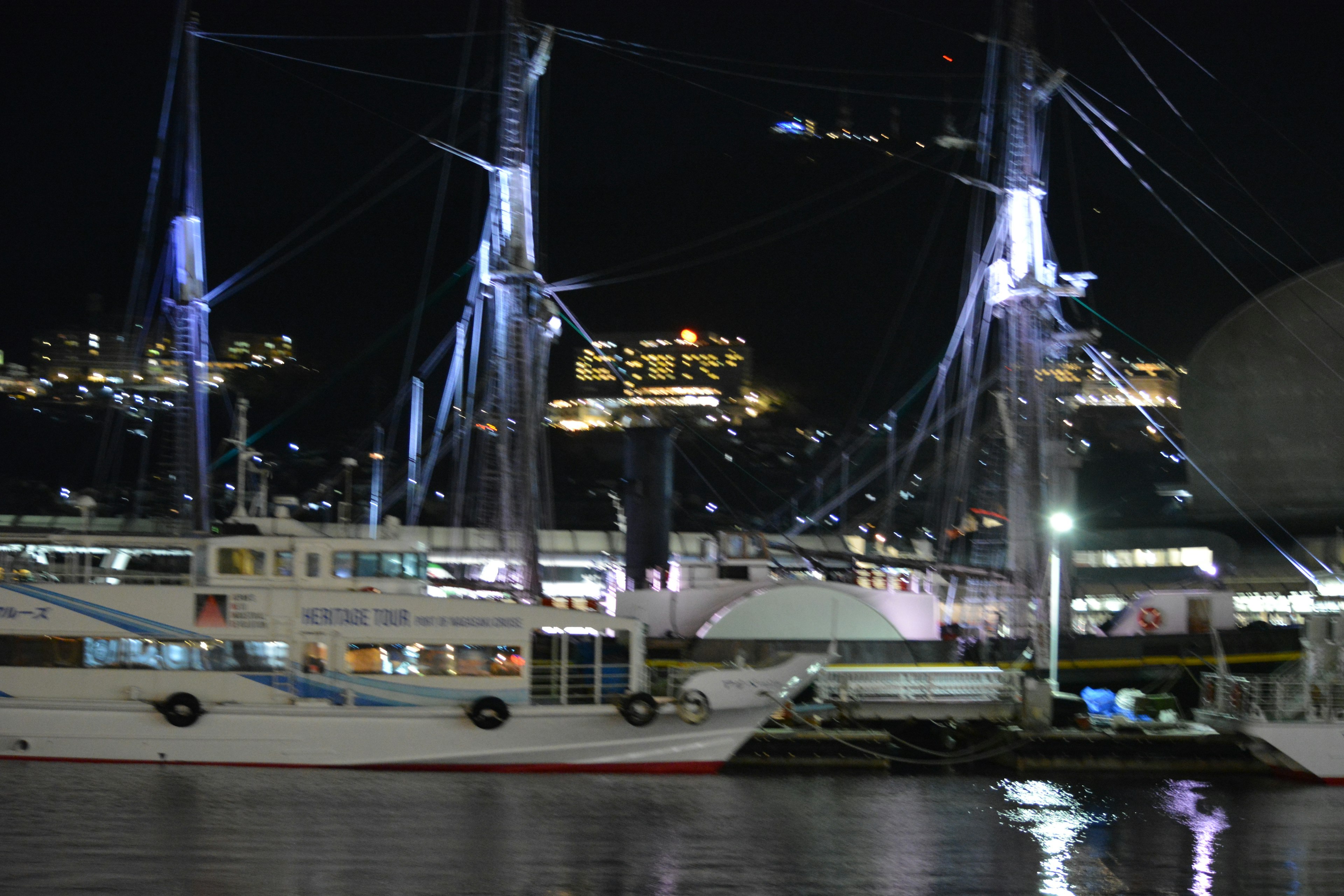 Beautiful view of a white sailing ship docked at night