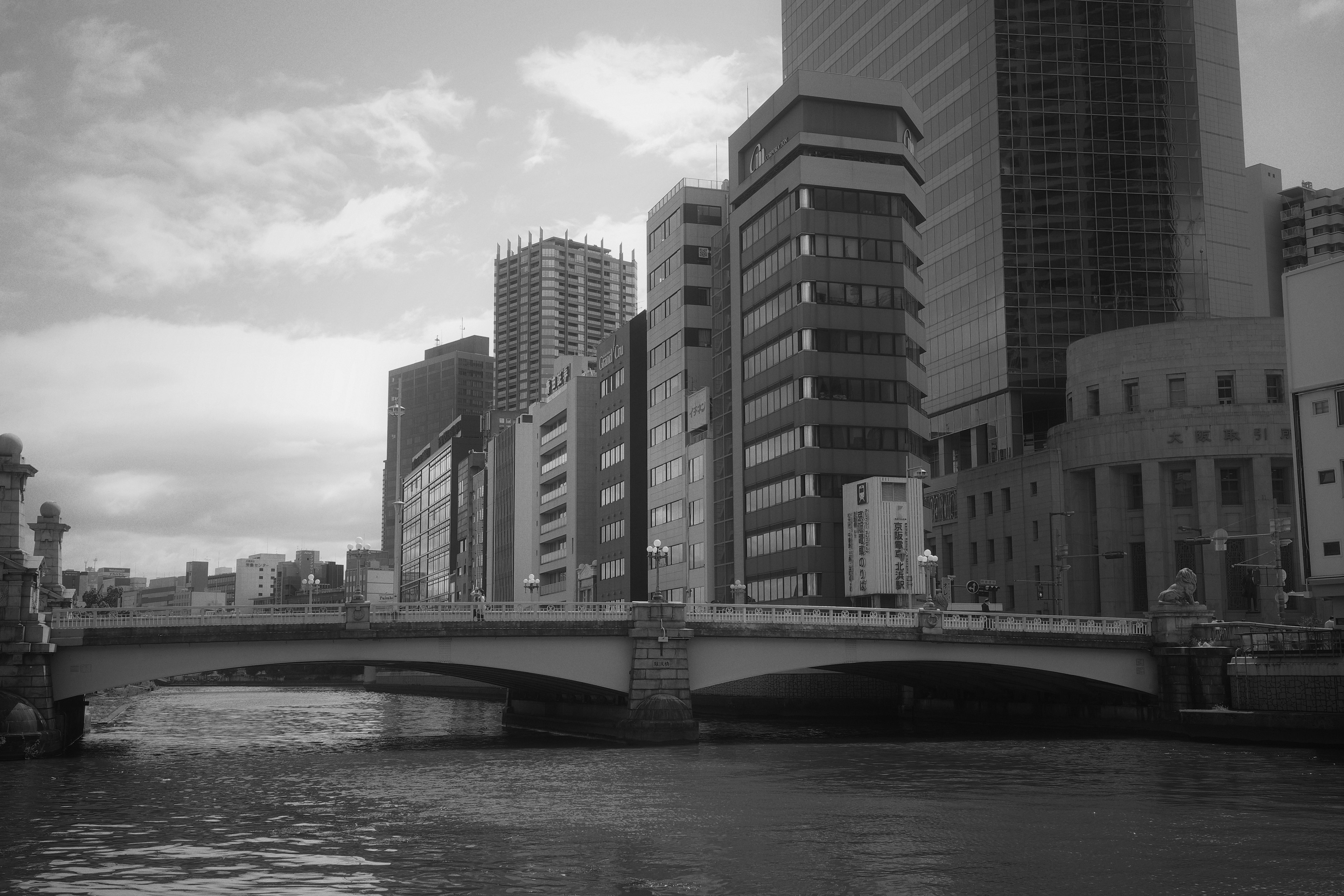 Black and white cityscape featuring a bridge and skyscrapers