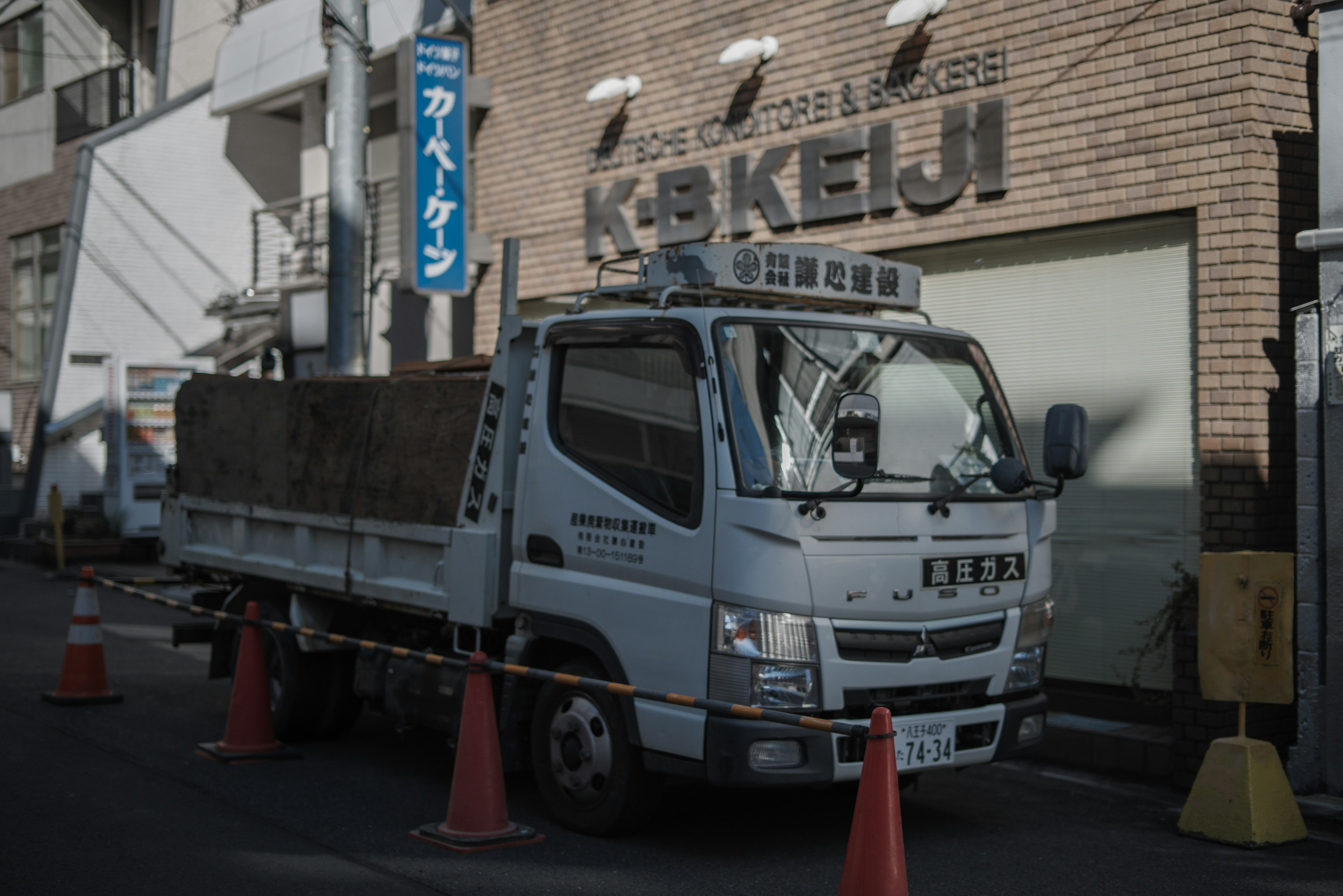 白色卡车停在城市环境中的橙色锥桶之间