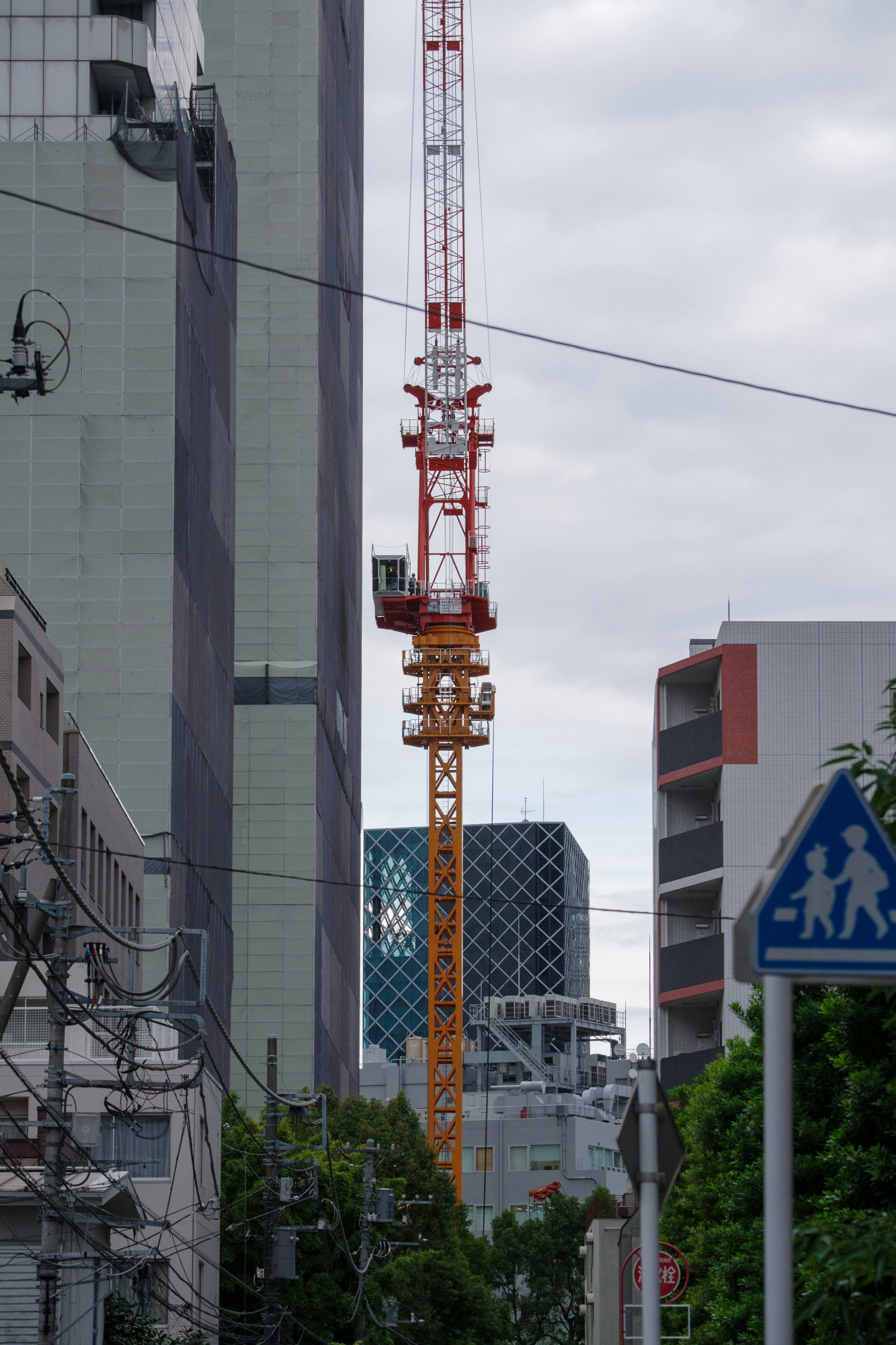 Crane towering between modern buildings in an urban setting