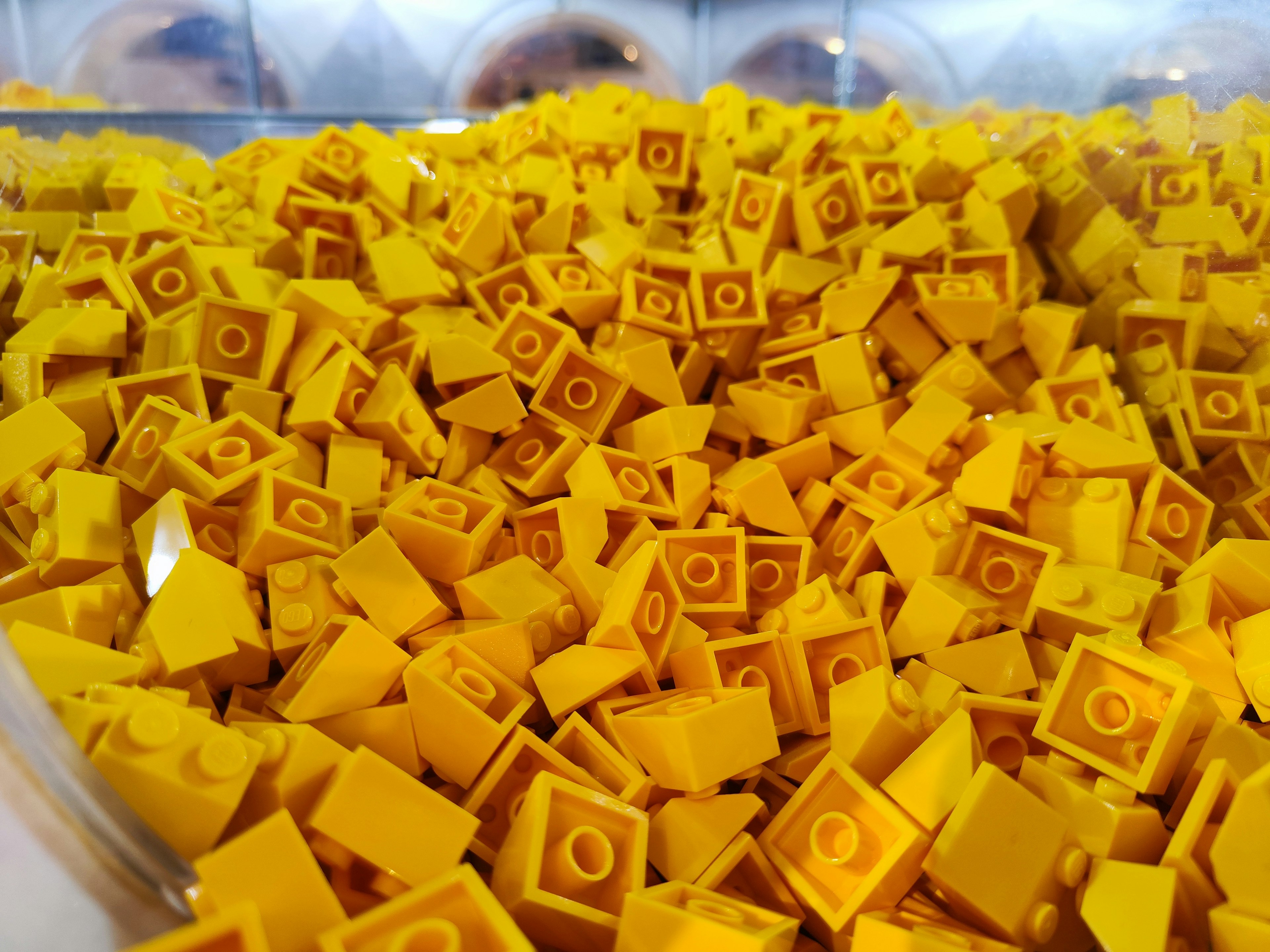 Un contenitore pieno di numerosi mattoncini LEGO gialli