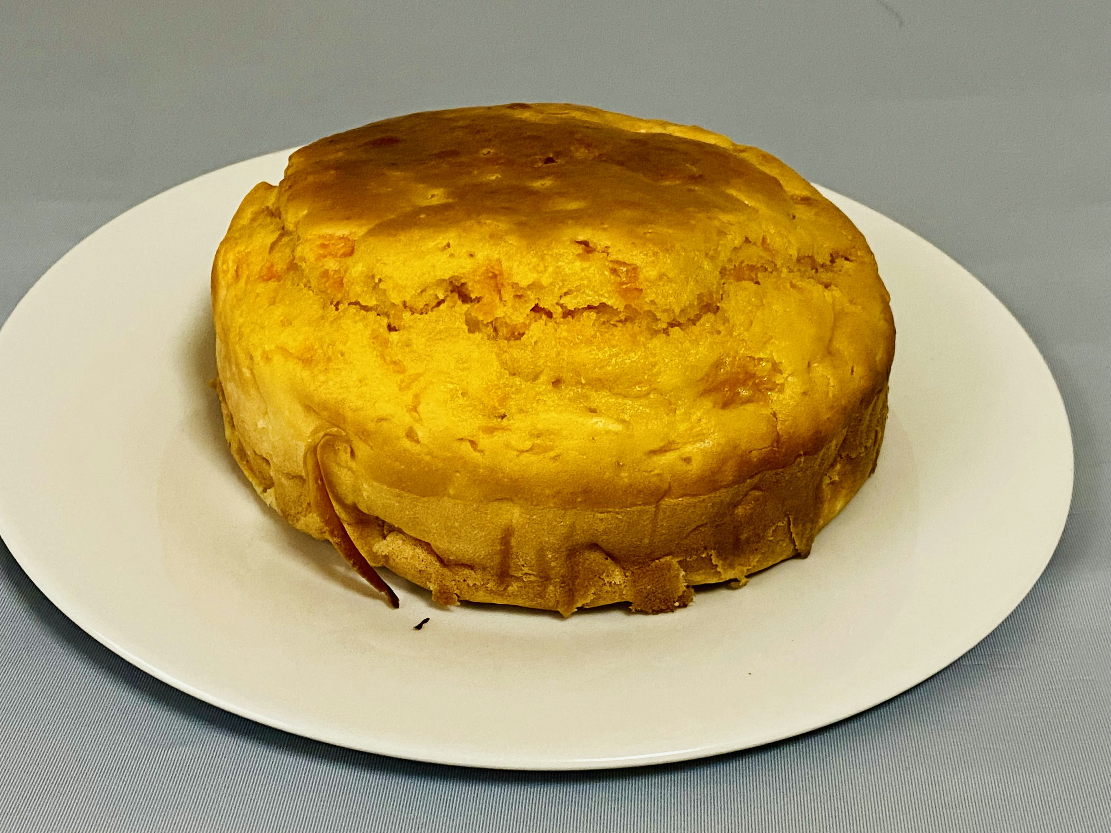 A yellow cake placed on a white plate