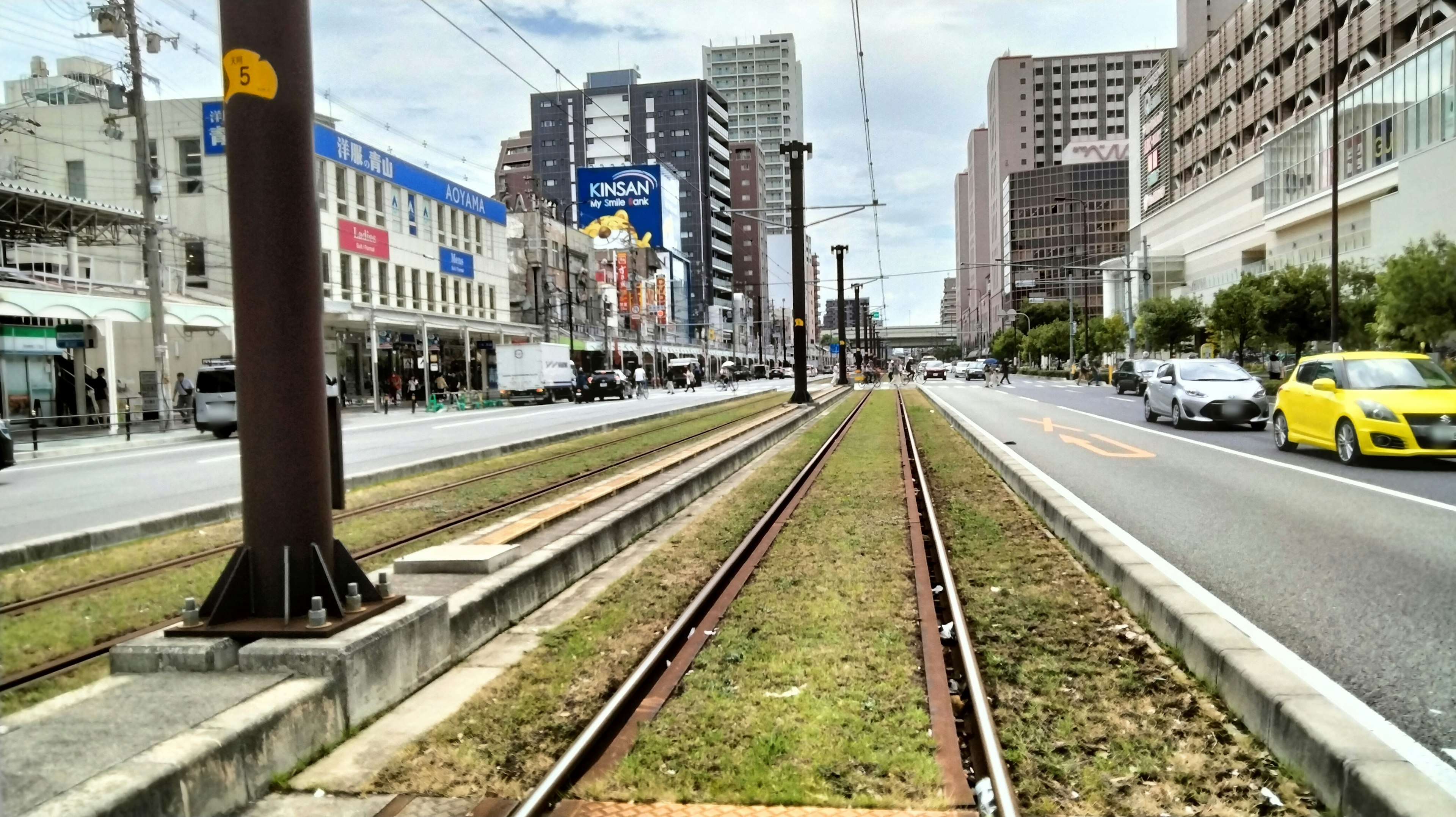 Cityscape featuring railway tracks and surrounding buildings