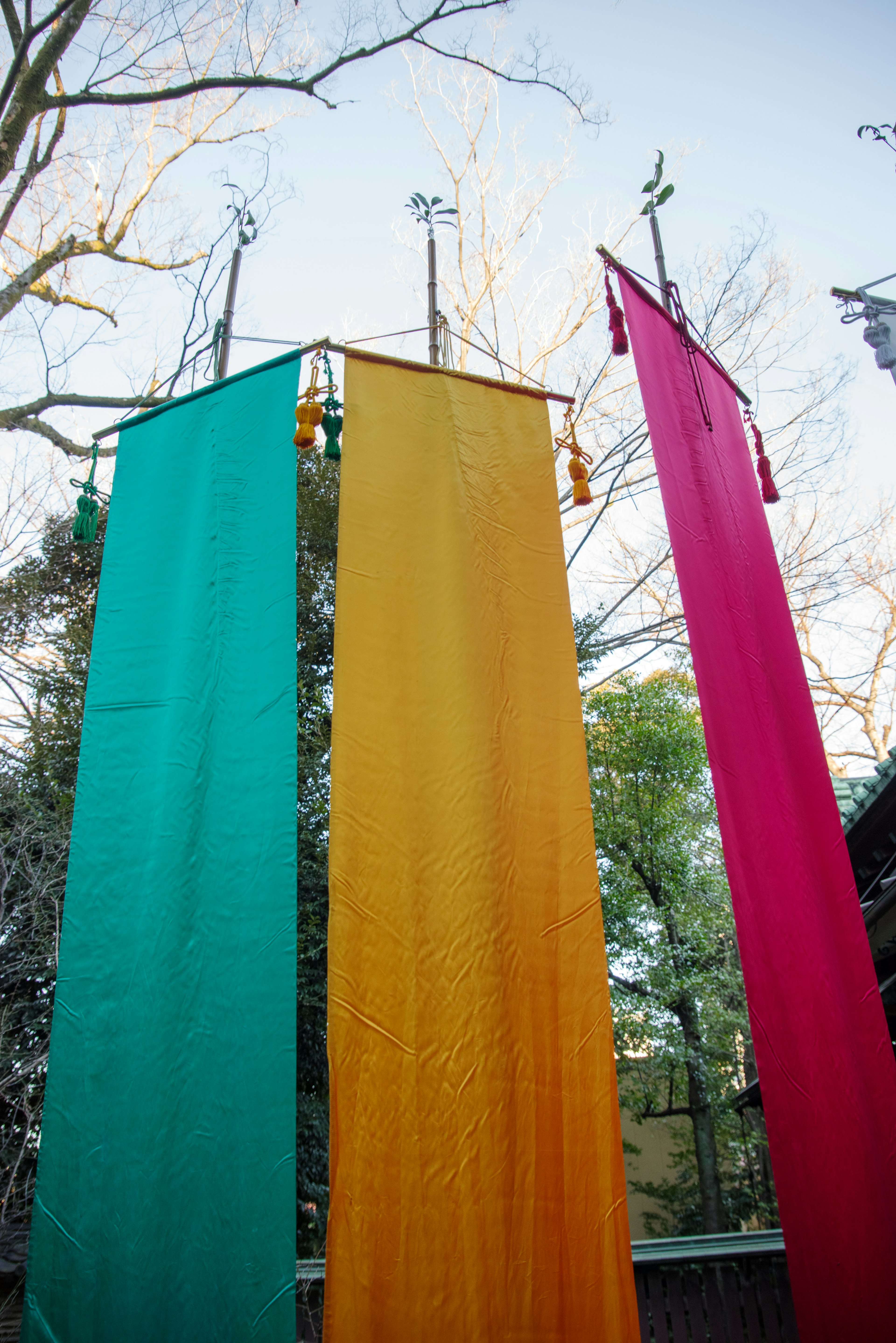 Colorful banners in green, yellow, and red hanging outdoors