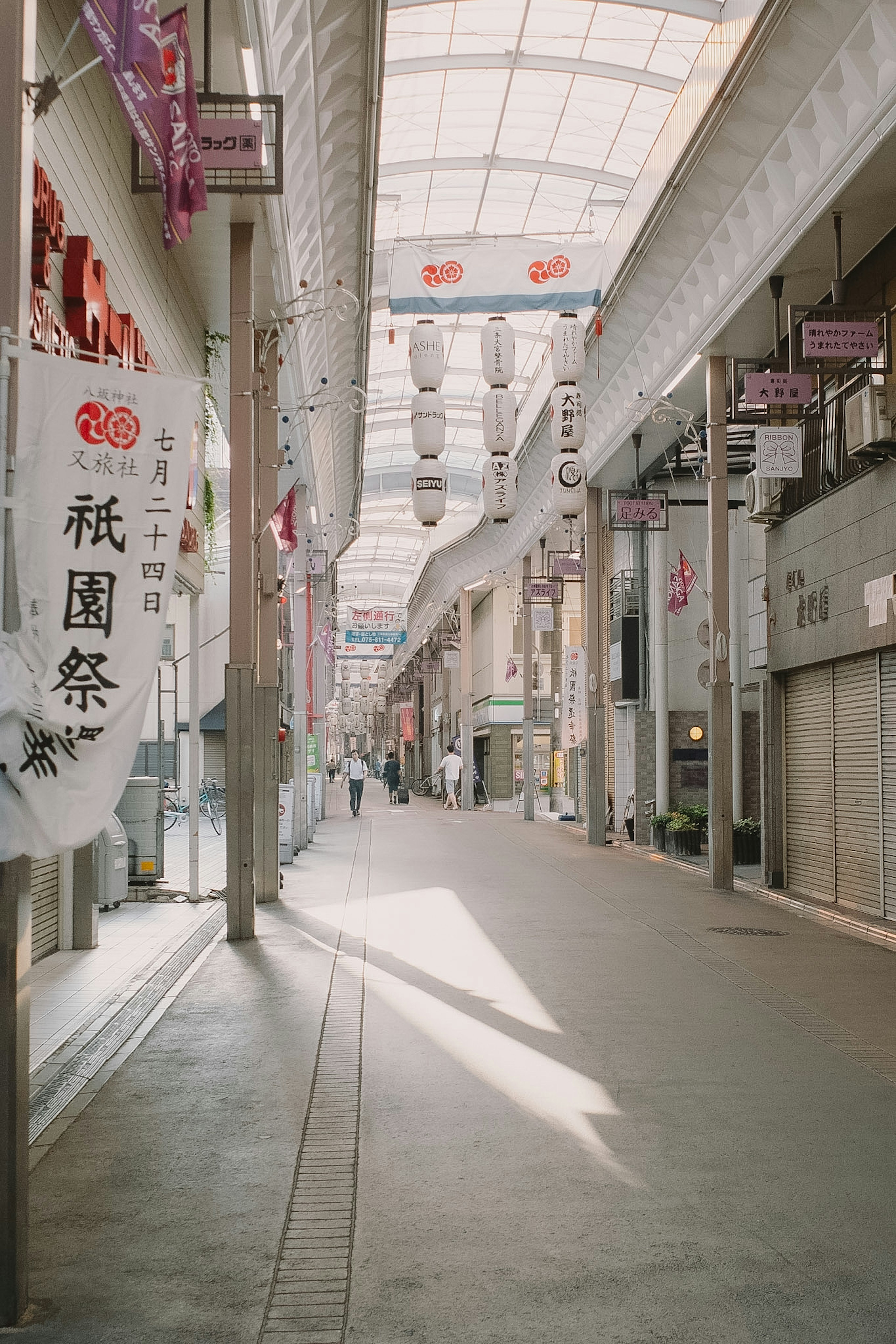 Quiet shopping street with banners and empty walkway