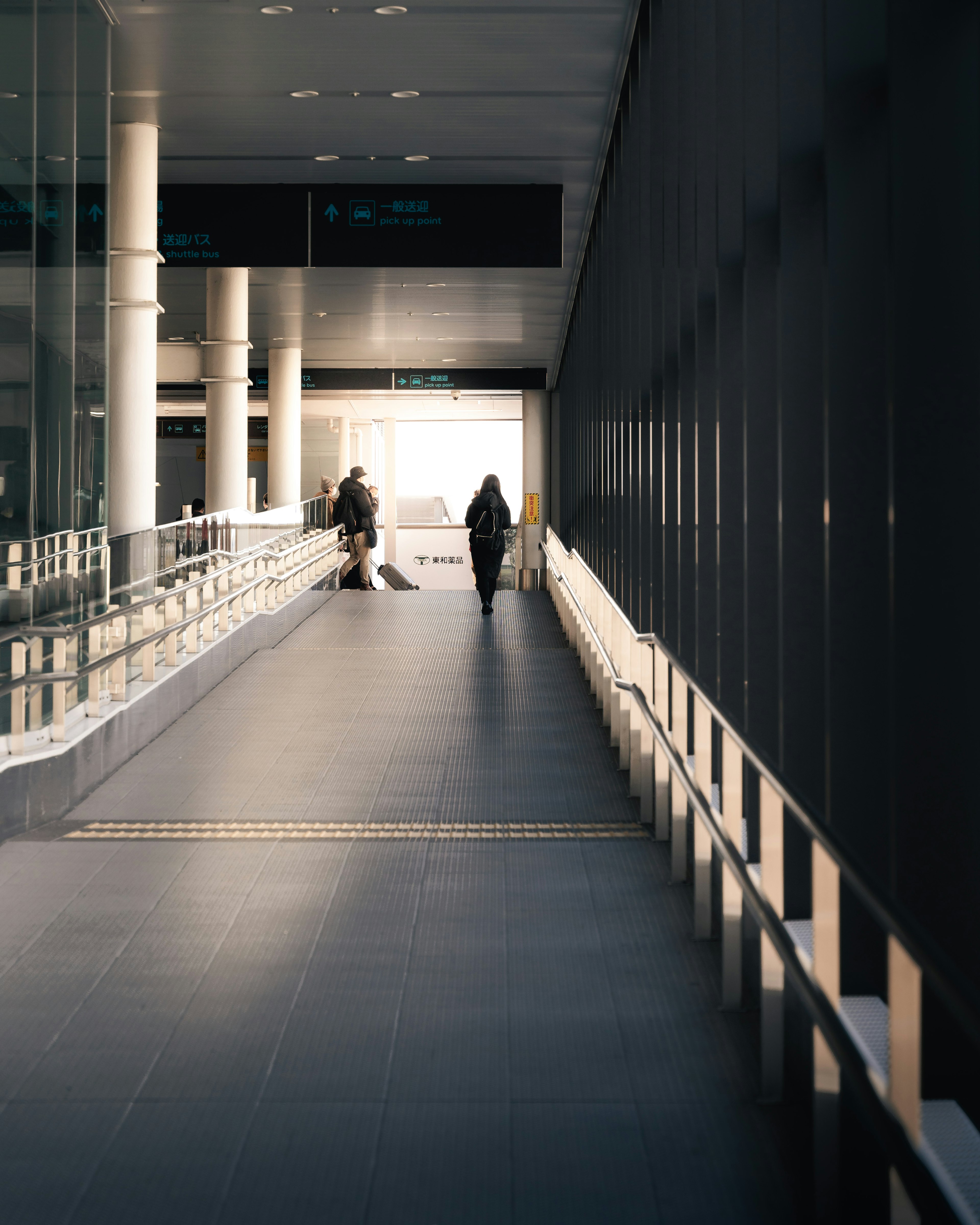 Bright corridor with people walking and modern architectural elements