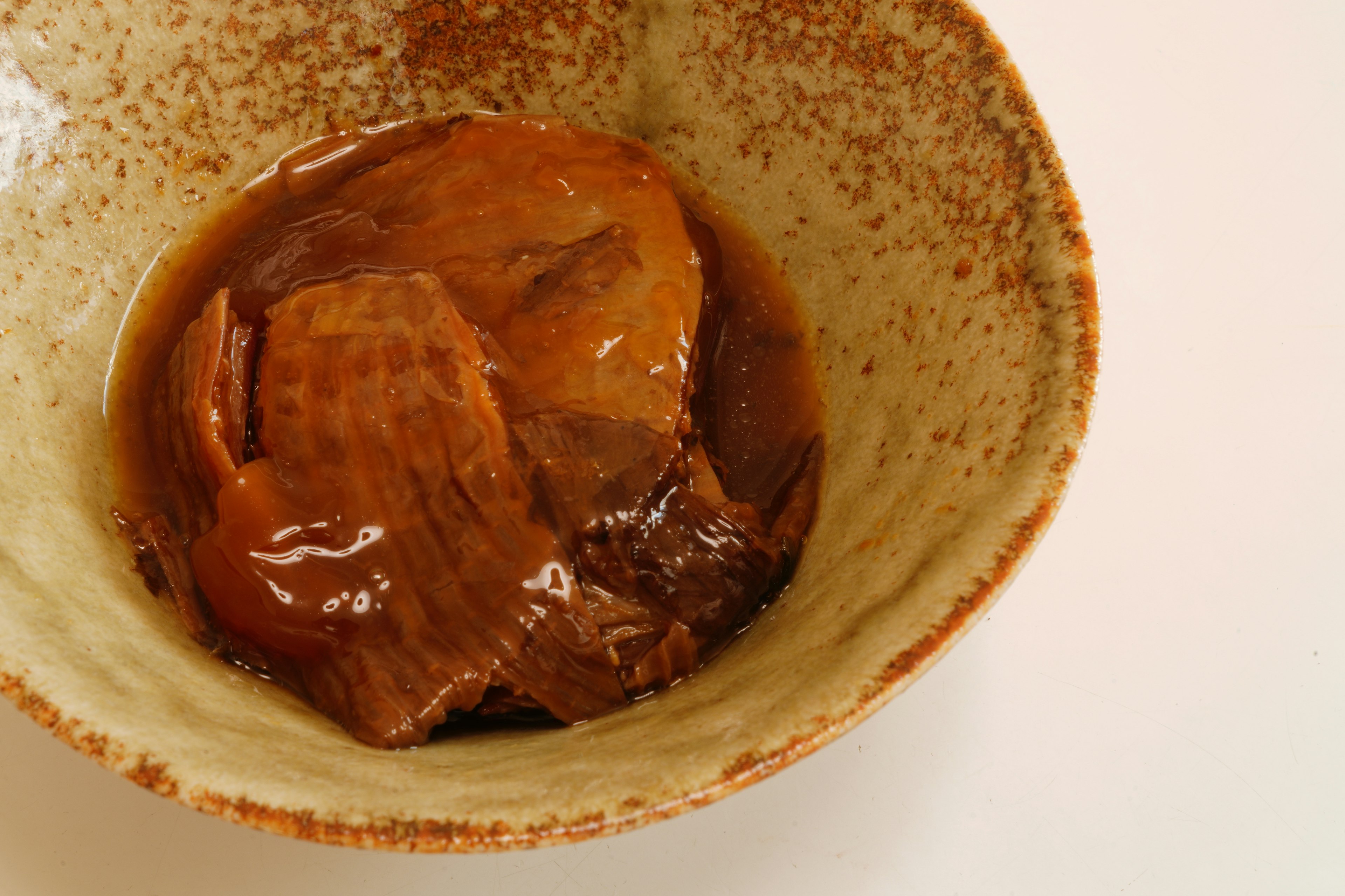 Brown meat served in a traditional Japanese bowl