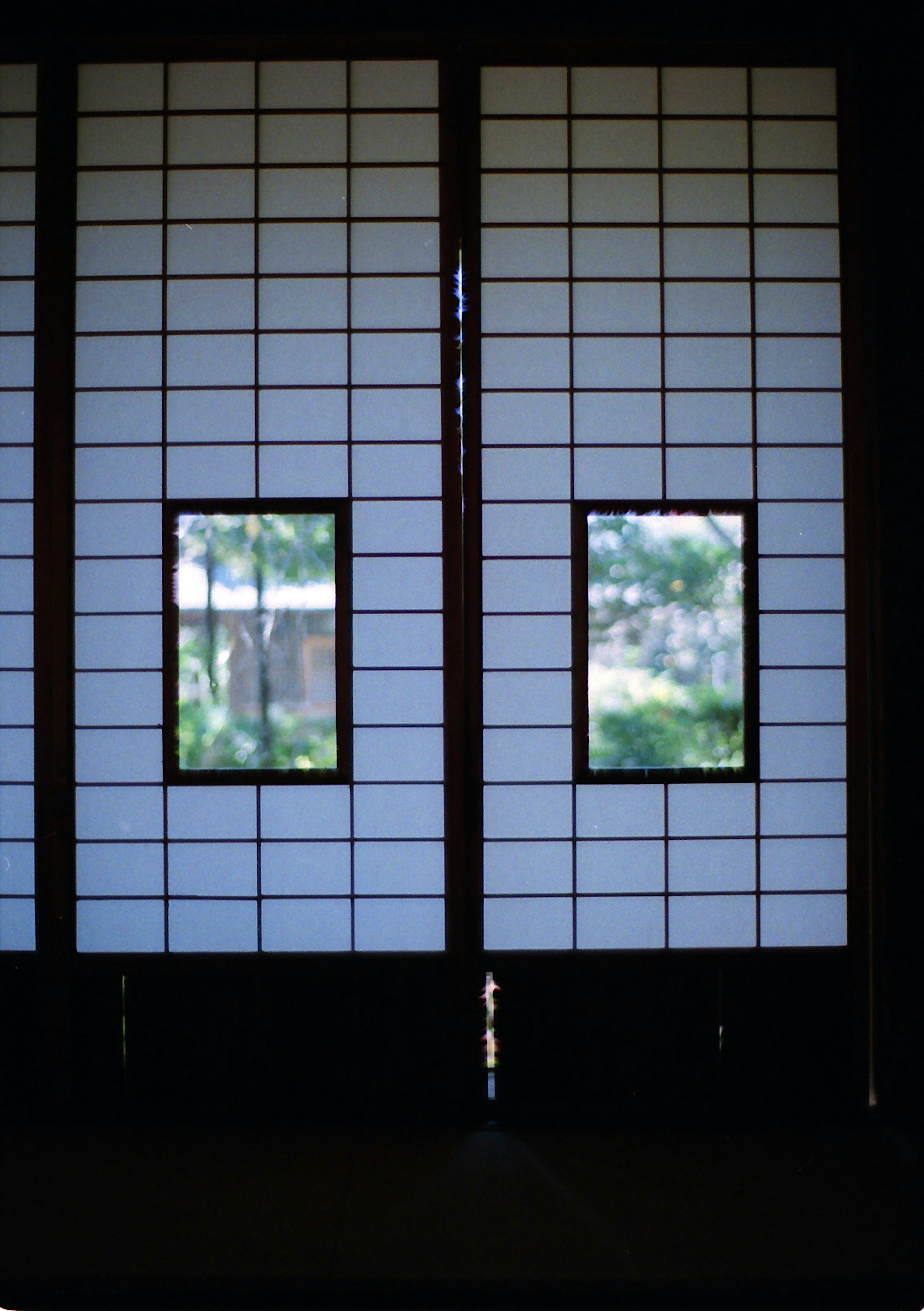 Interior view featuring traditional Japanese shoji screens with square windows