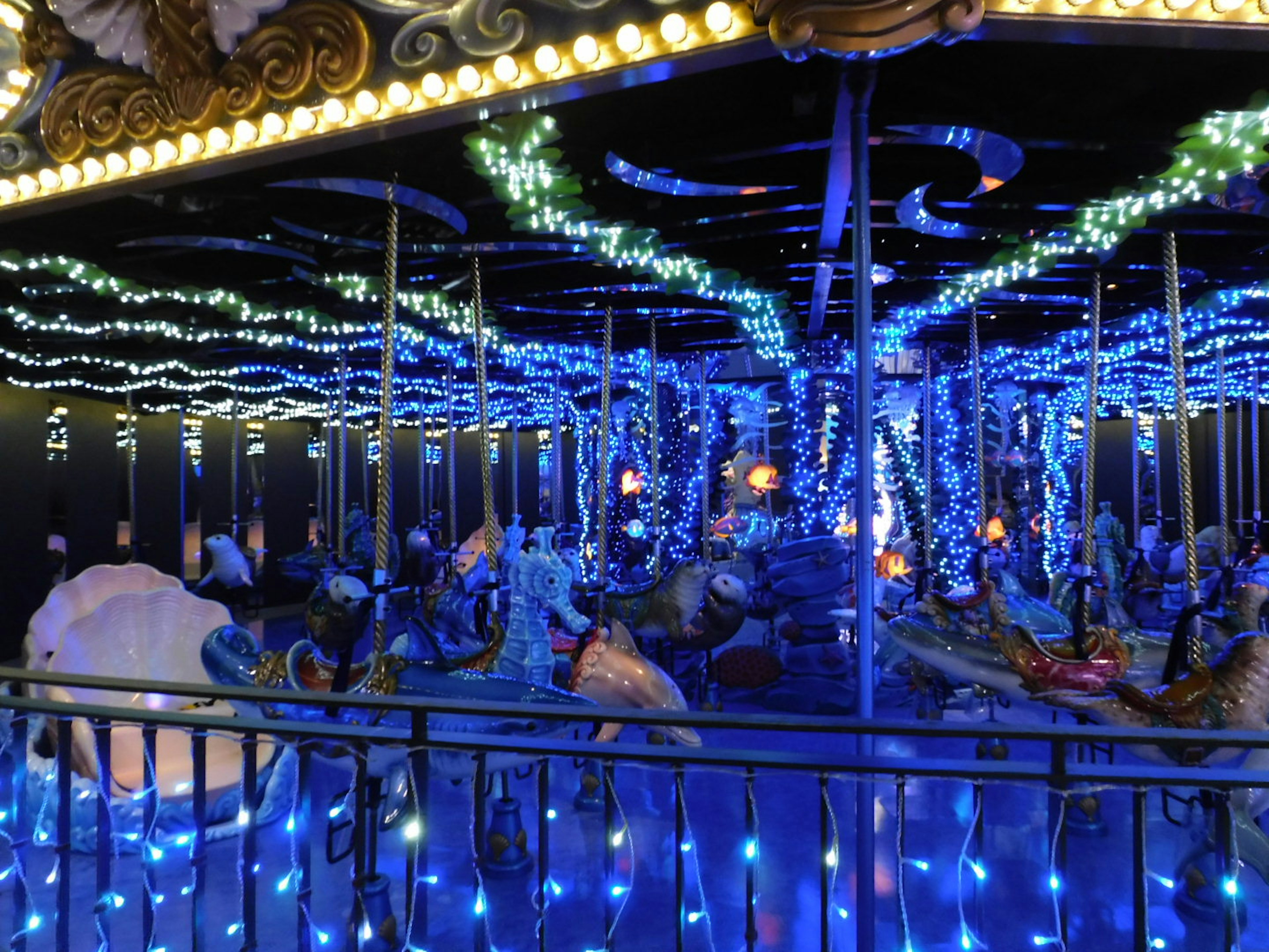 Interior view of a carousel illuminated with blue lights