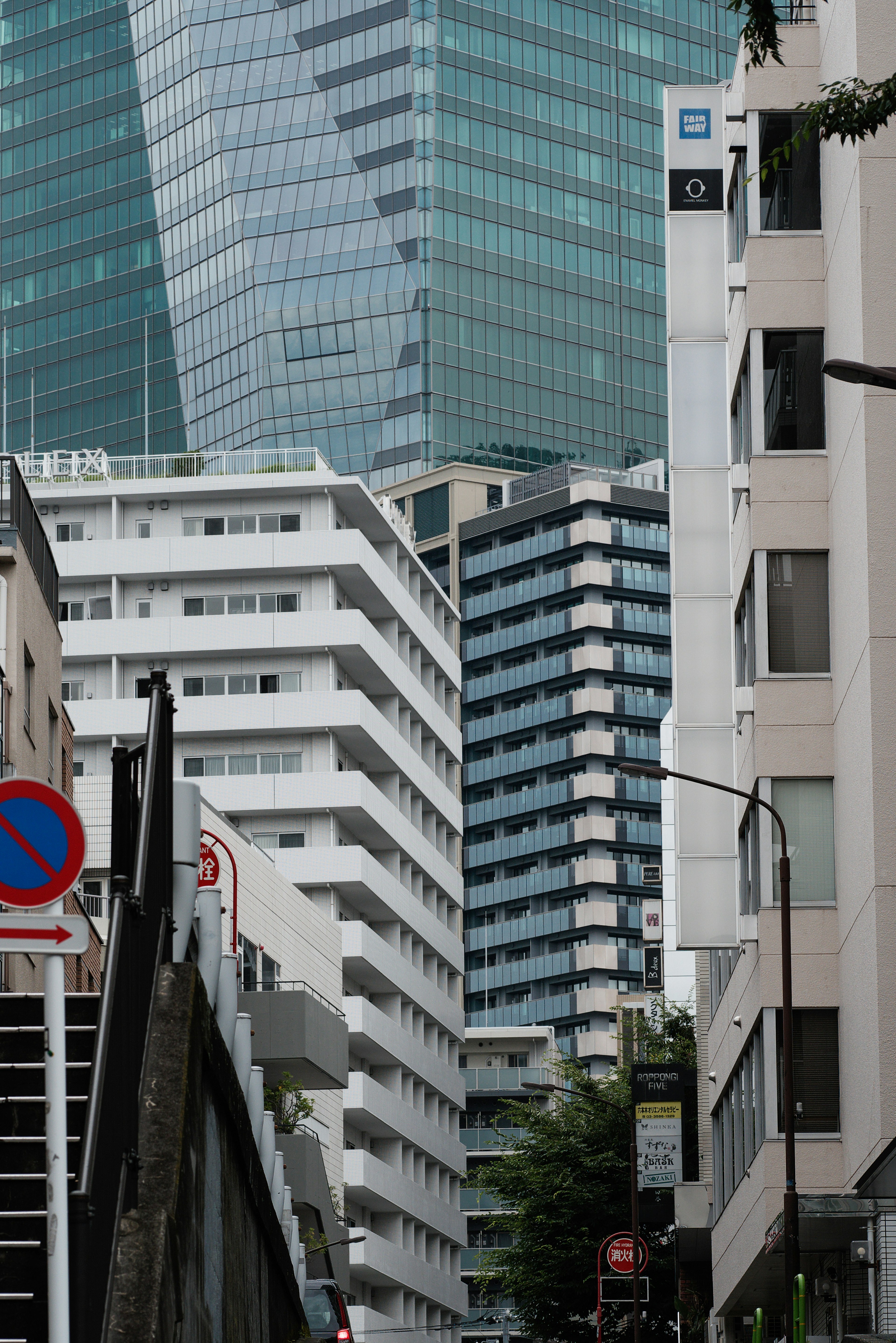 Cityscape featuring overlapping buildings with glass facades and white structures