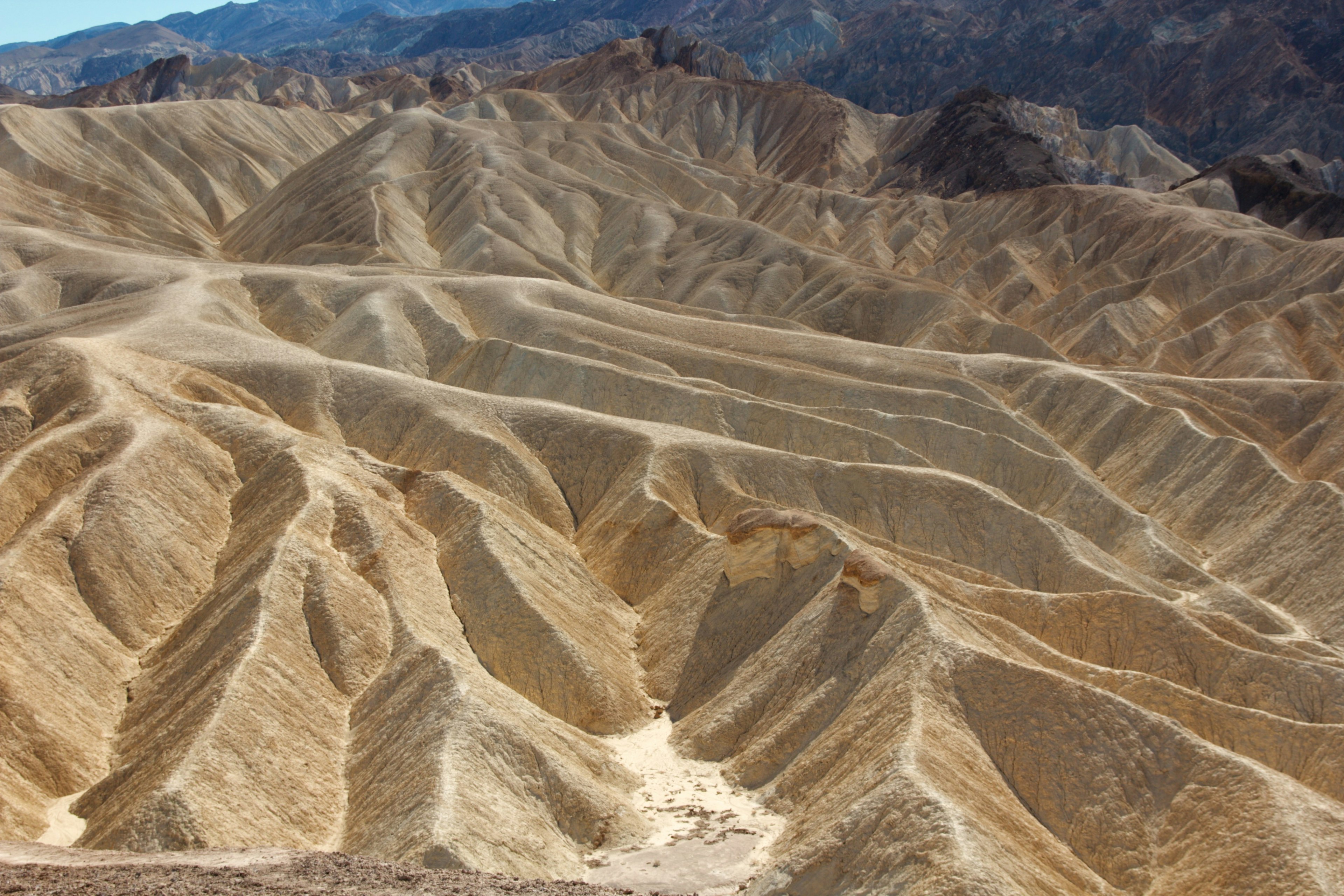 Dry mountainous landscape of Death Valley with wave-like terrain