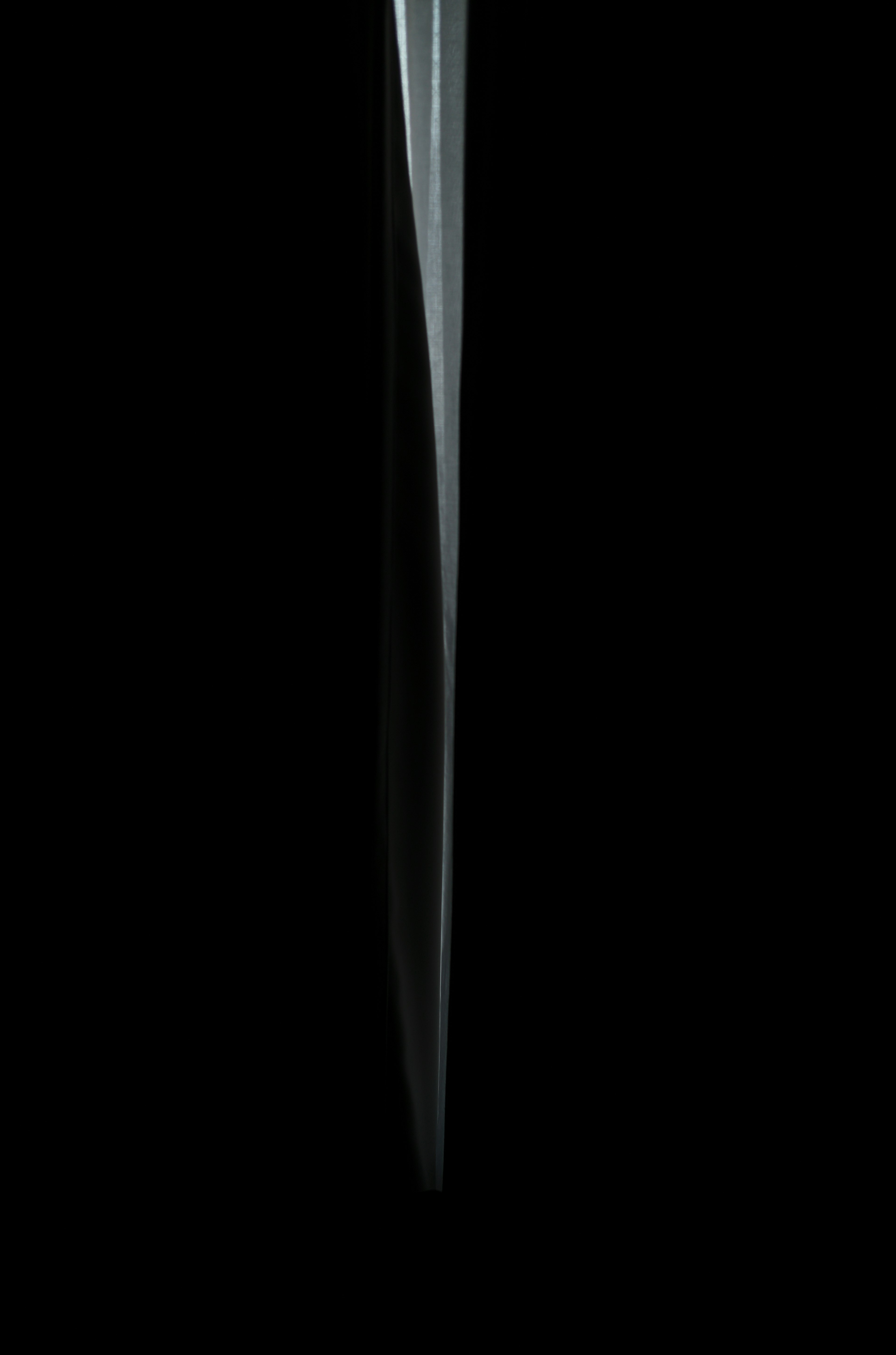 Sleek sharp blade design against a black background