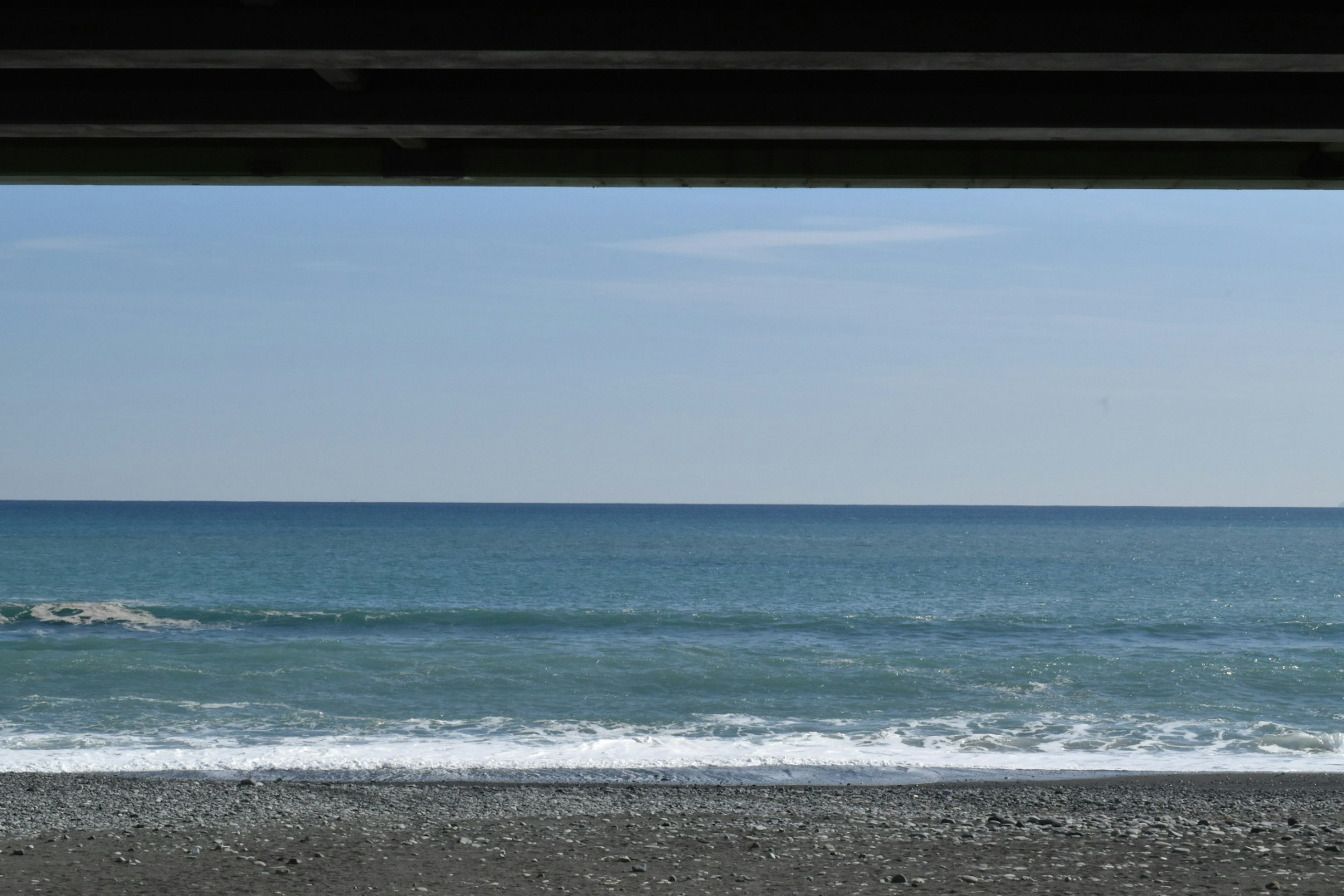 View of the sea and sky from under a structure