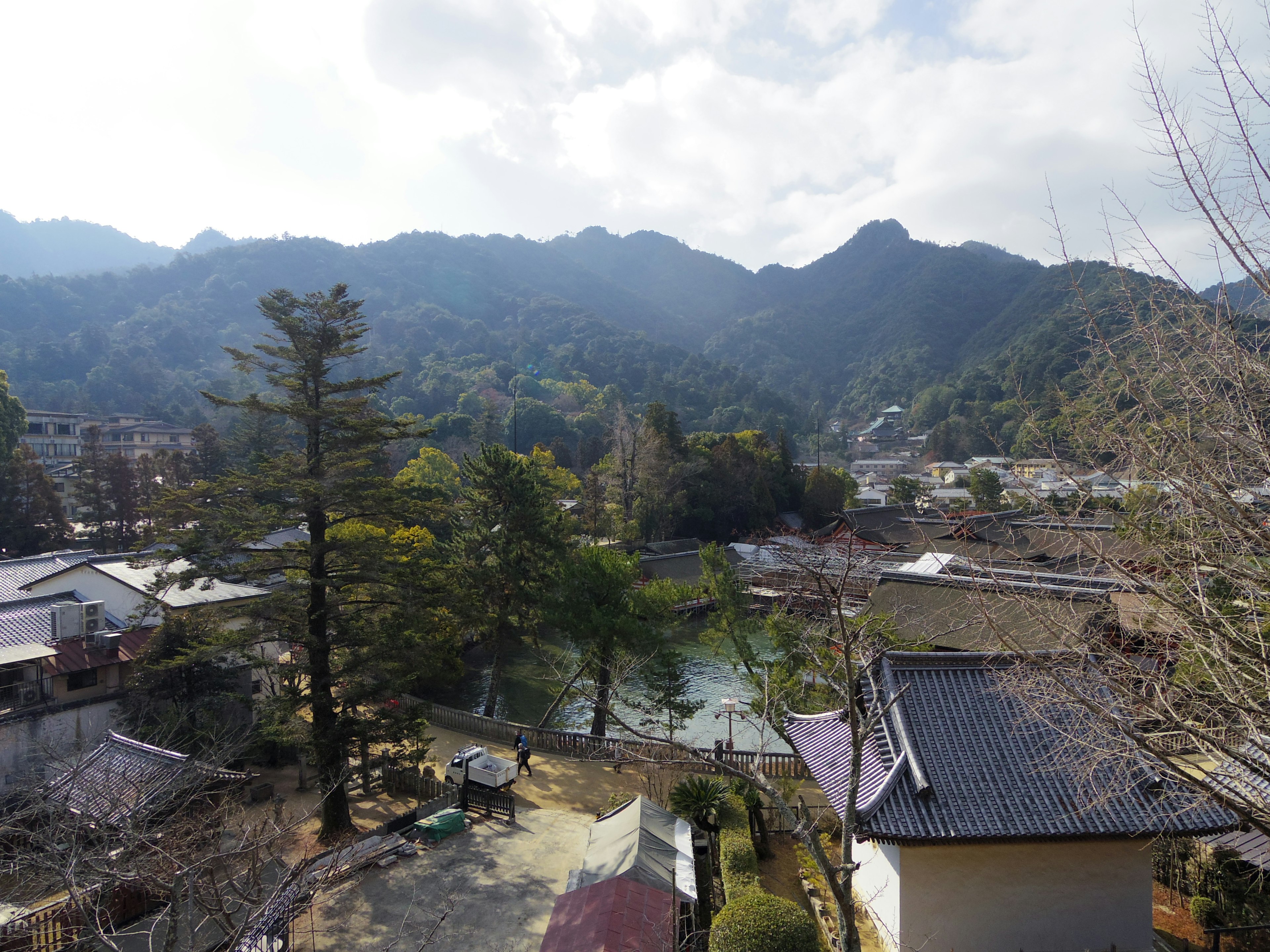 Scenic view of a tranquil village with mountains and a river