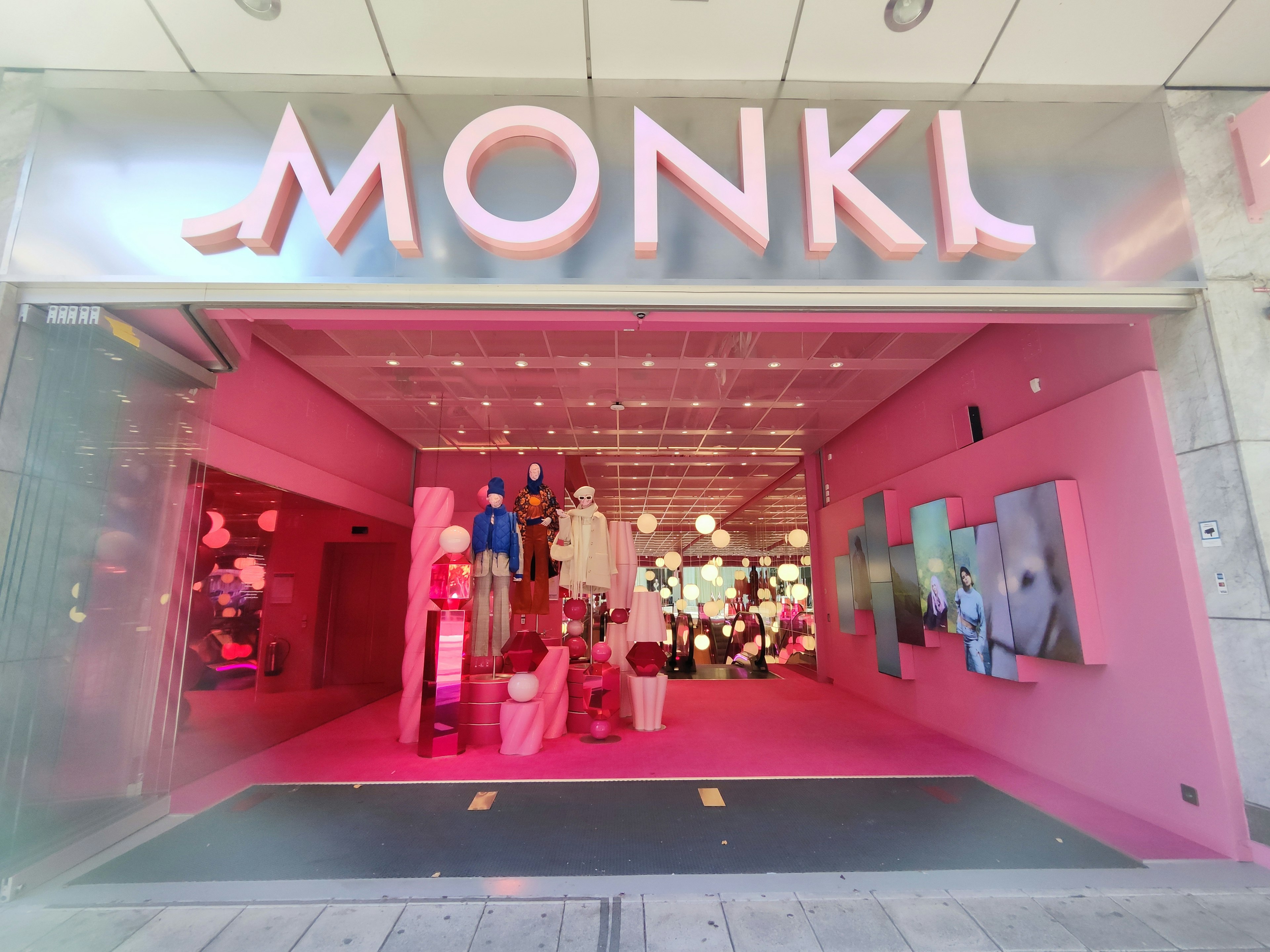 Fachada rosa de la tienda MONKI con decoraciones vibrantes