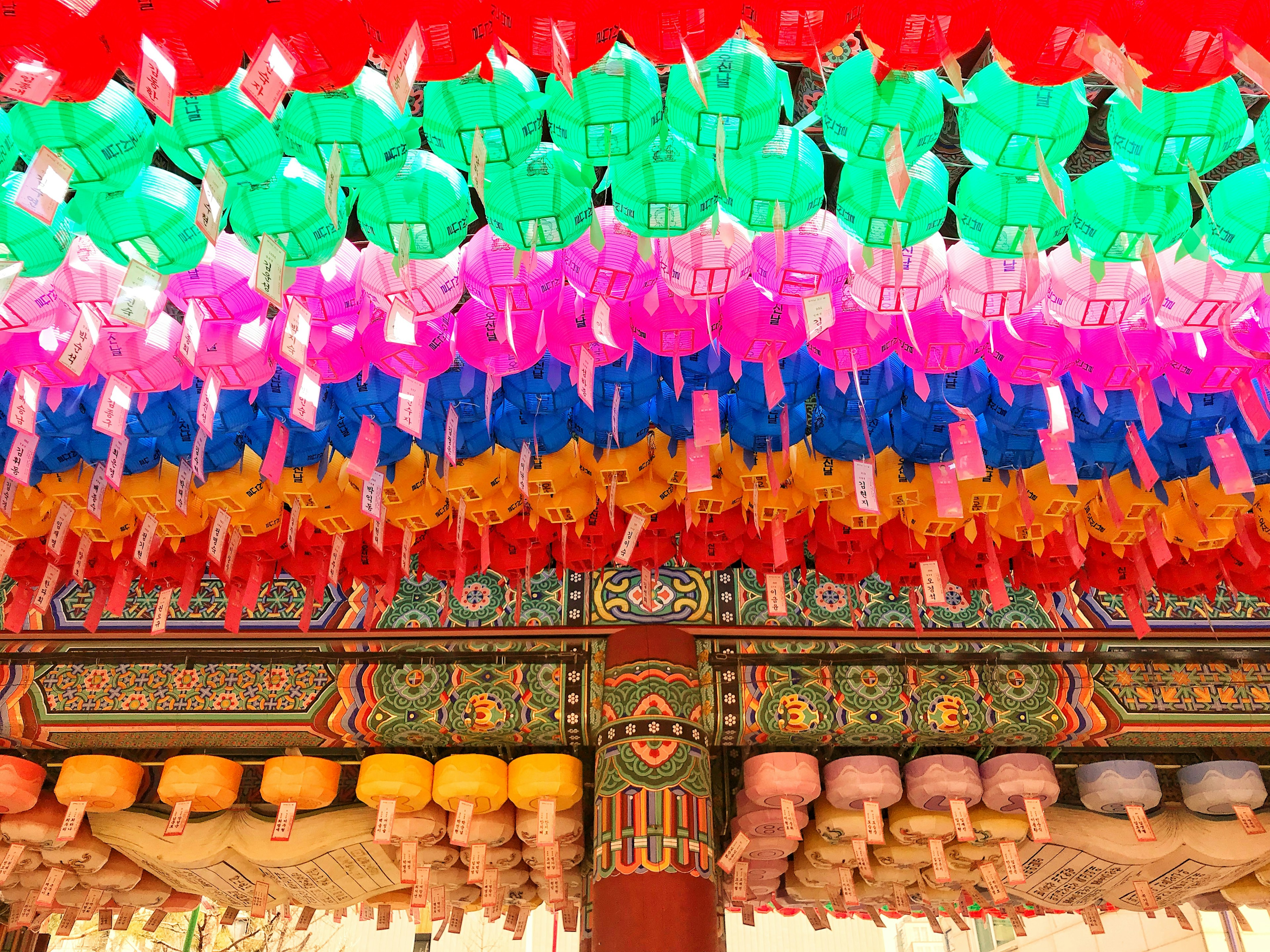 Colorful lanterns hanging from a temple ceiling