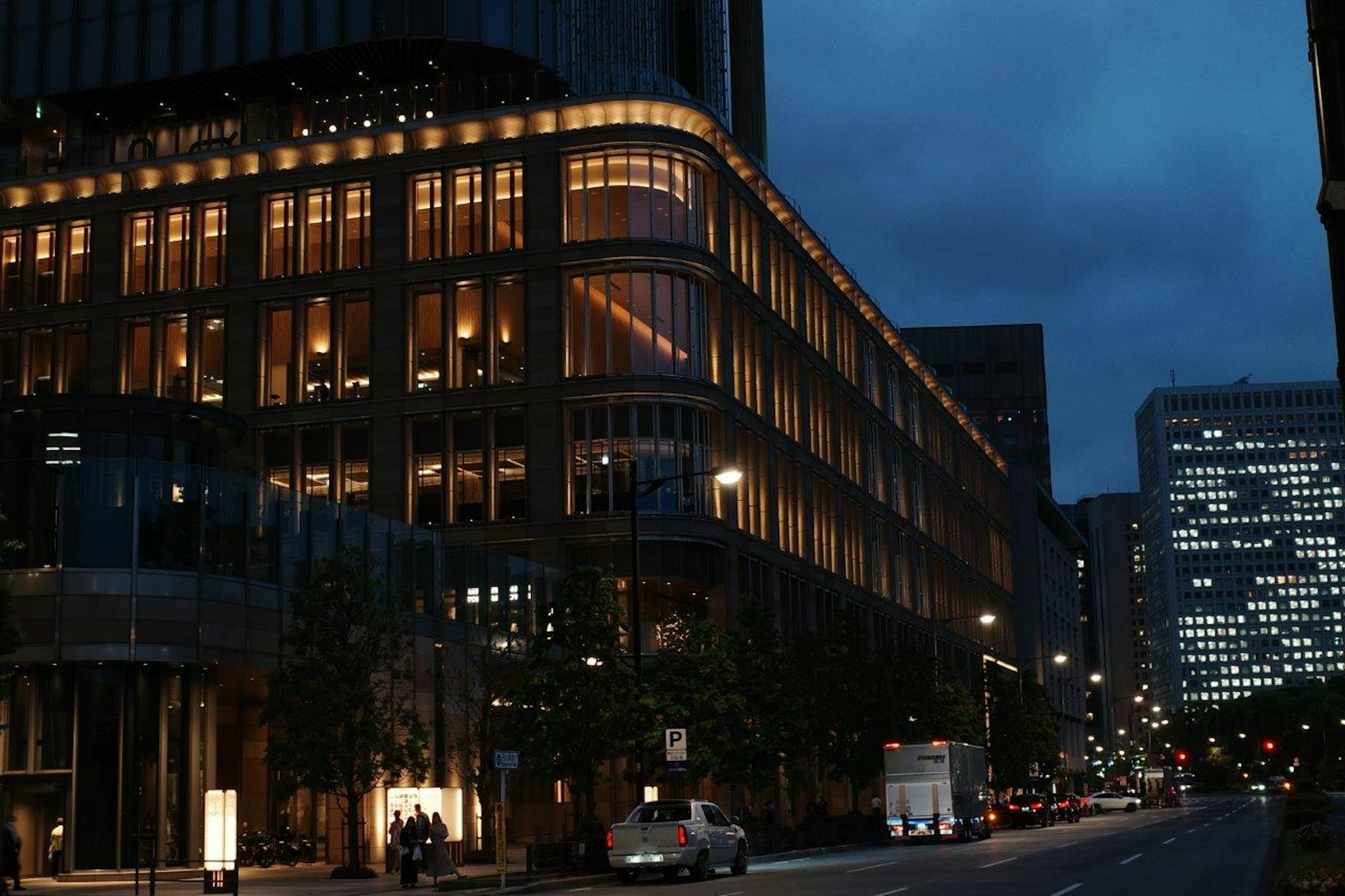 Illuminated building exterior at night with street view