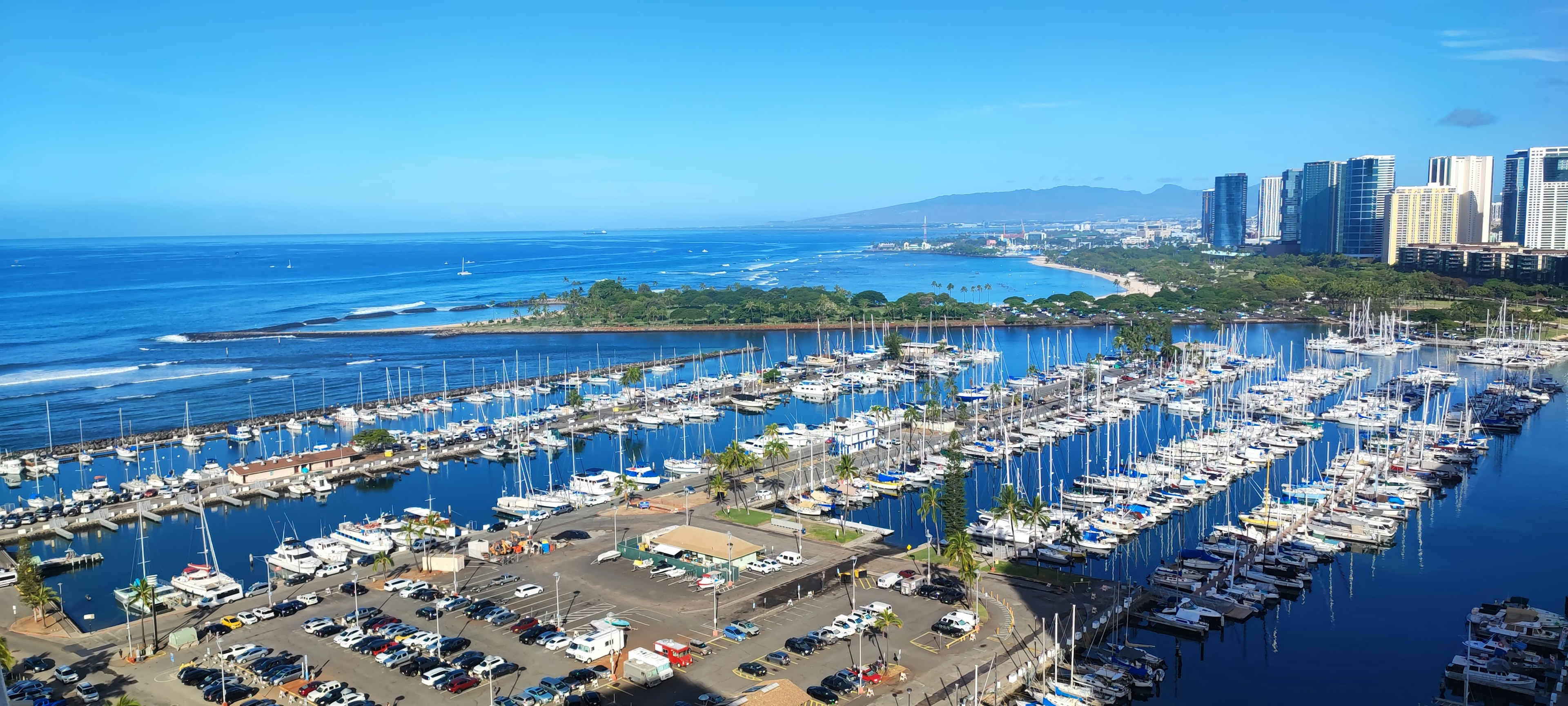 Aerial view of a marina with yachts and blue ocean in Hawaii