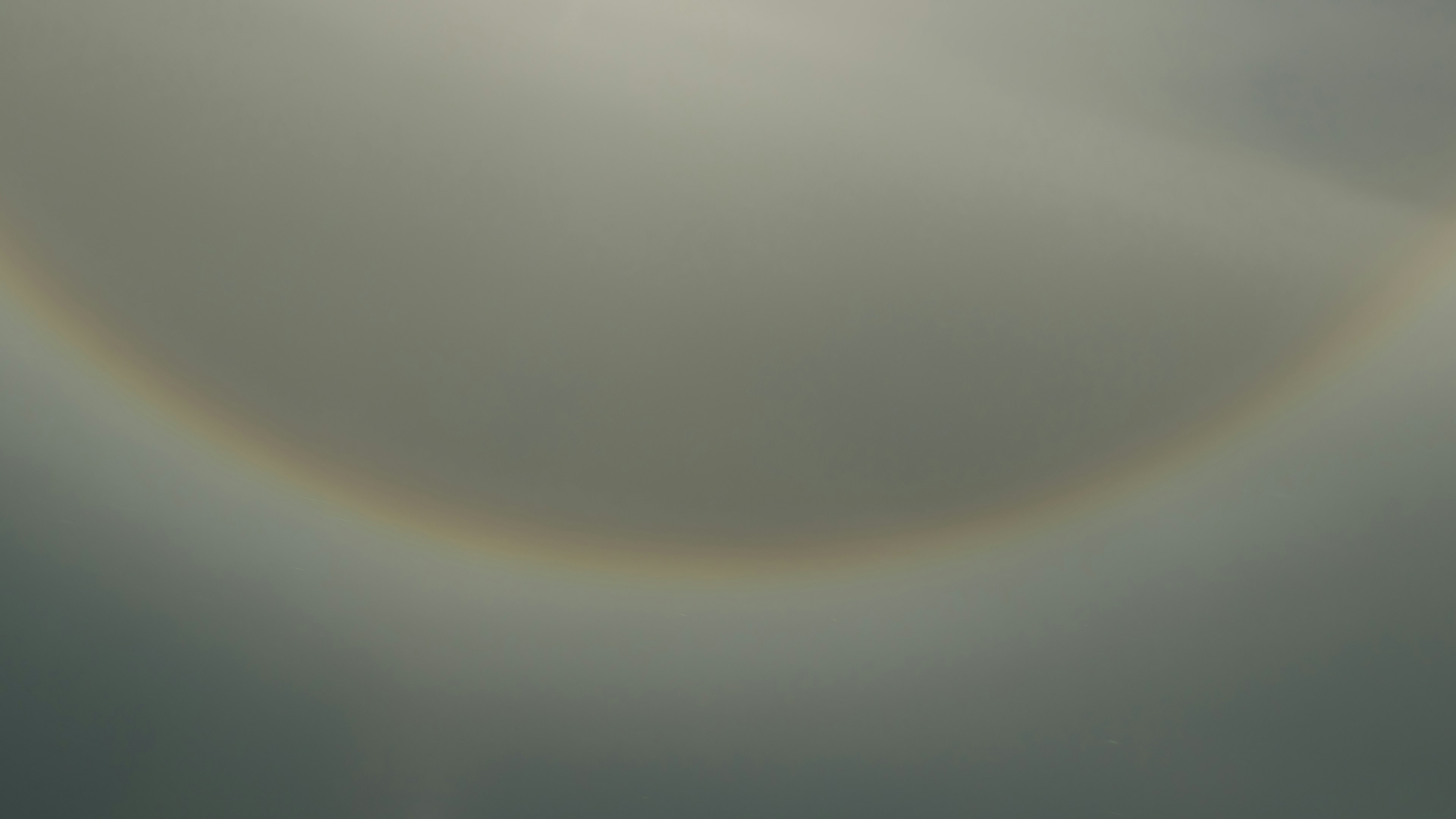 Image showing a faint rainbow arc against a muted background