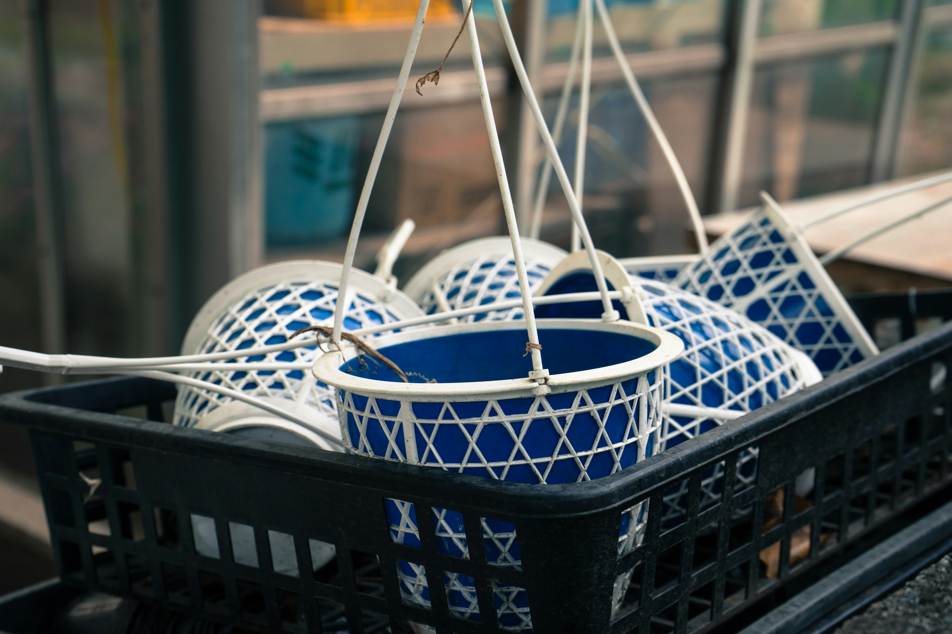 Blue patterned baskets hanging in a black container