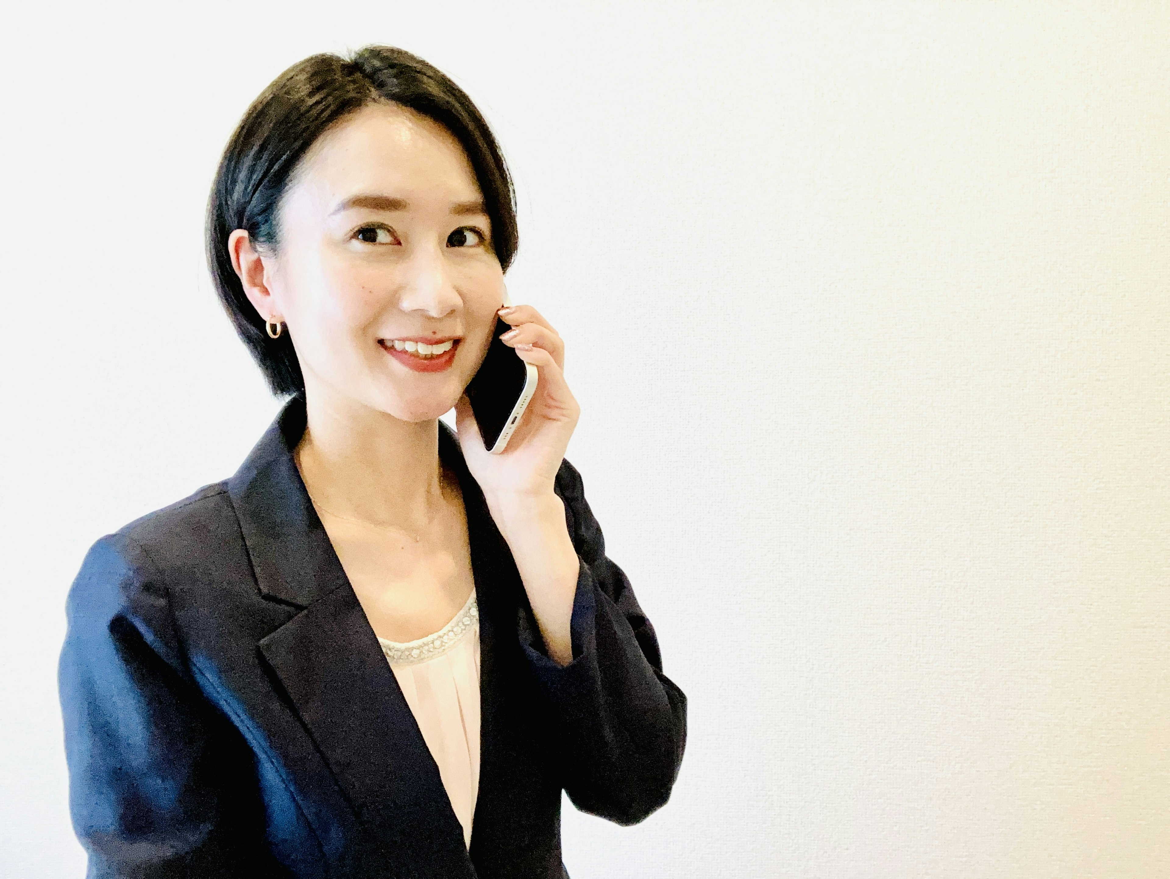 A woman in a business suit talking on a phone