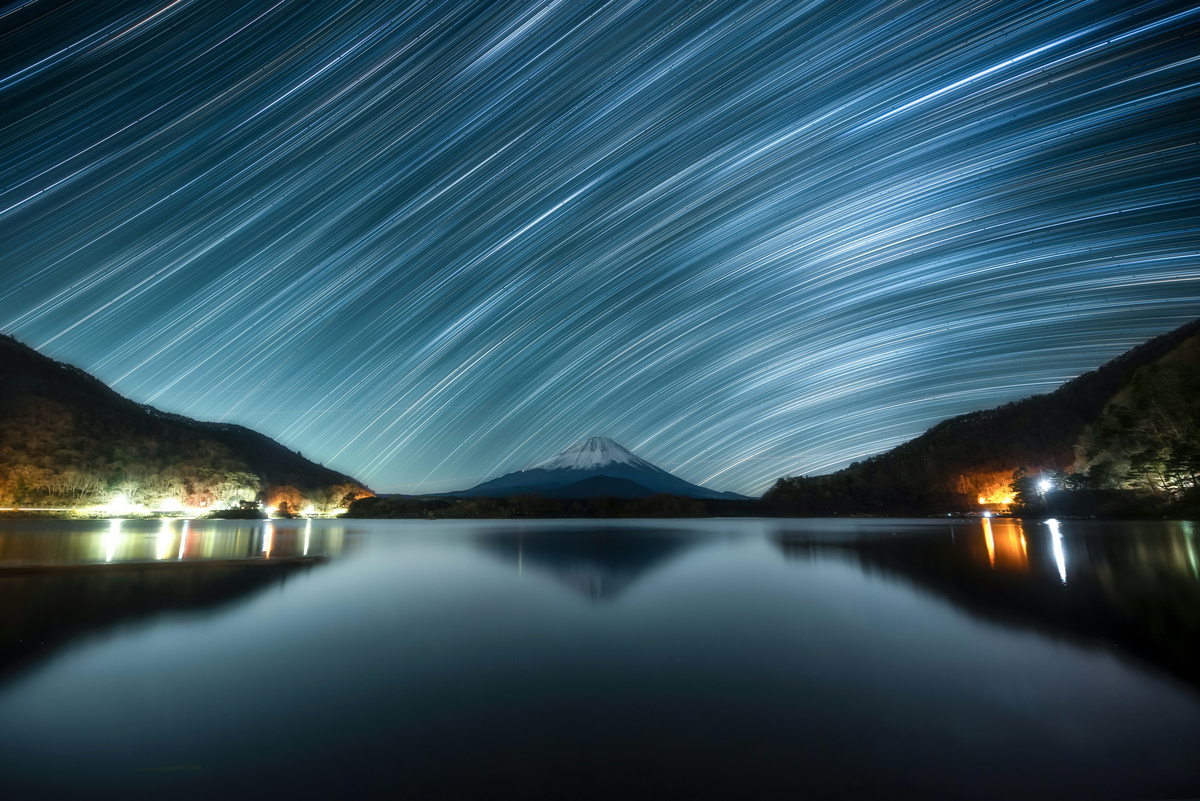 星空の軌跡が映る湖と富士山の風景