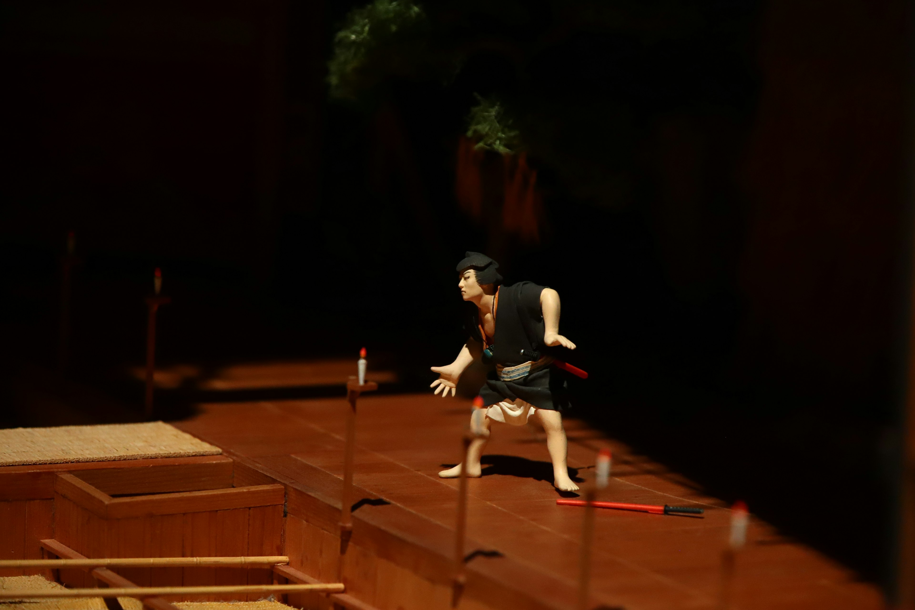 A puppet striking a pose on a wooden stage